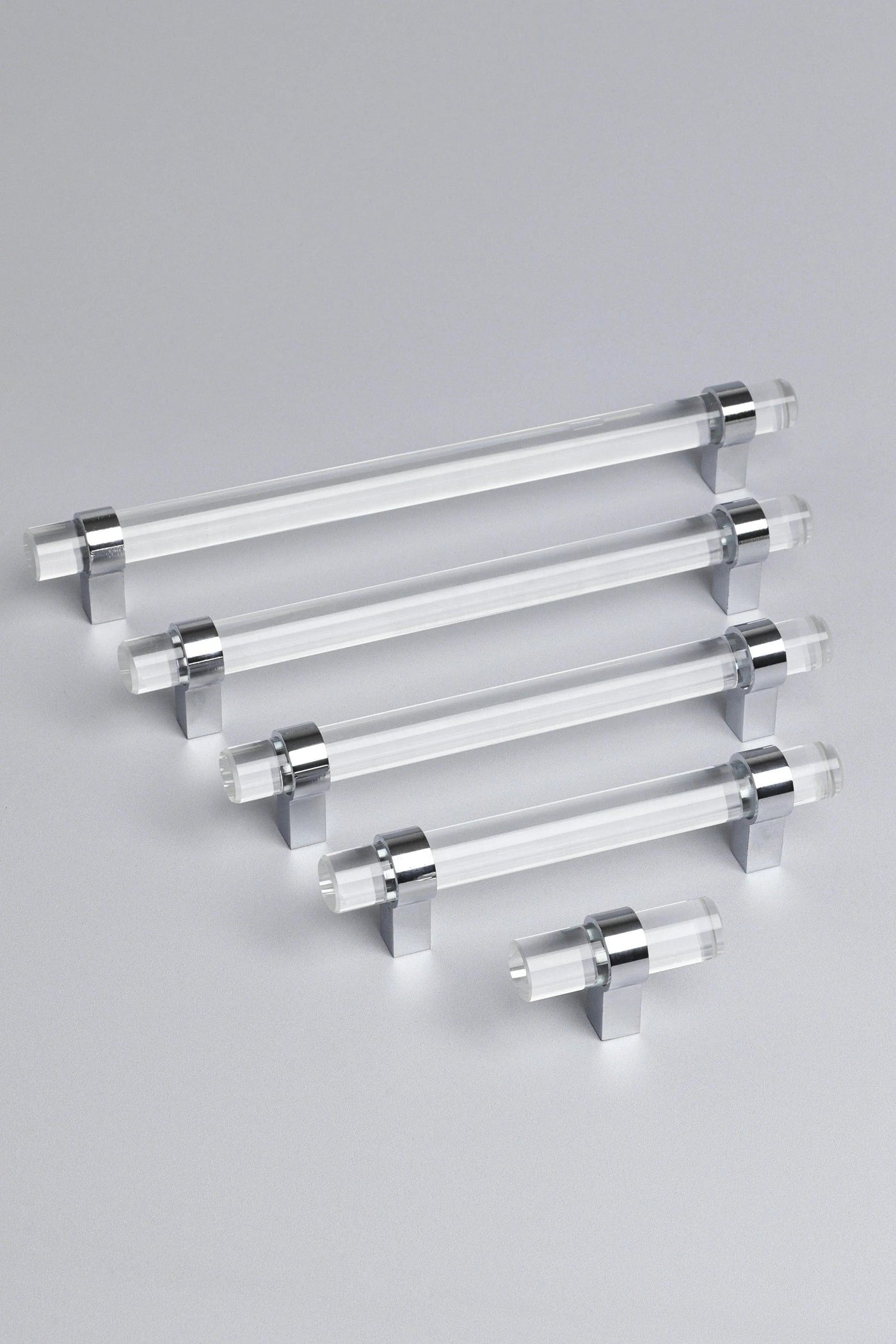 A cabinet pull-vs-knob comparison — Prismé clear faceted glass cabinet pull handle with chrome mounts, set against a painted kitchen cabinet | G Decor