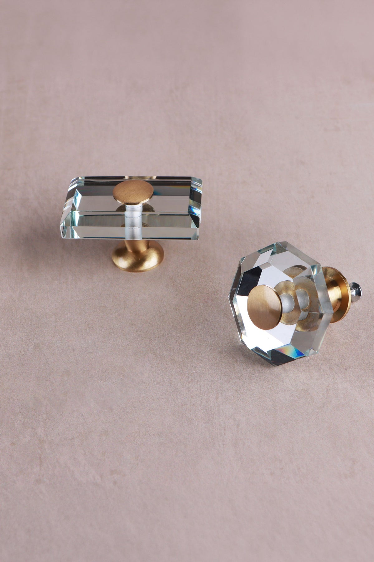Octagon and rectangle clear crystal glass knobs from above, showing the bevelled edges and brass caps