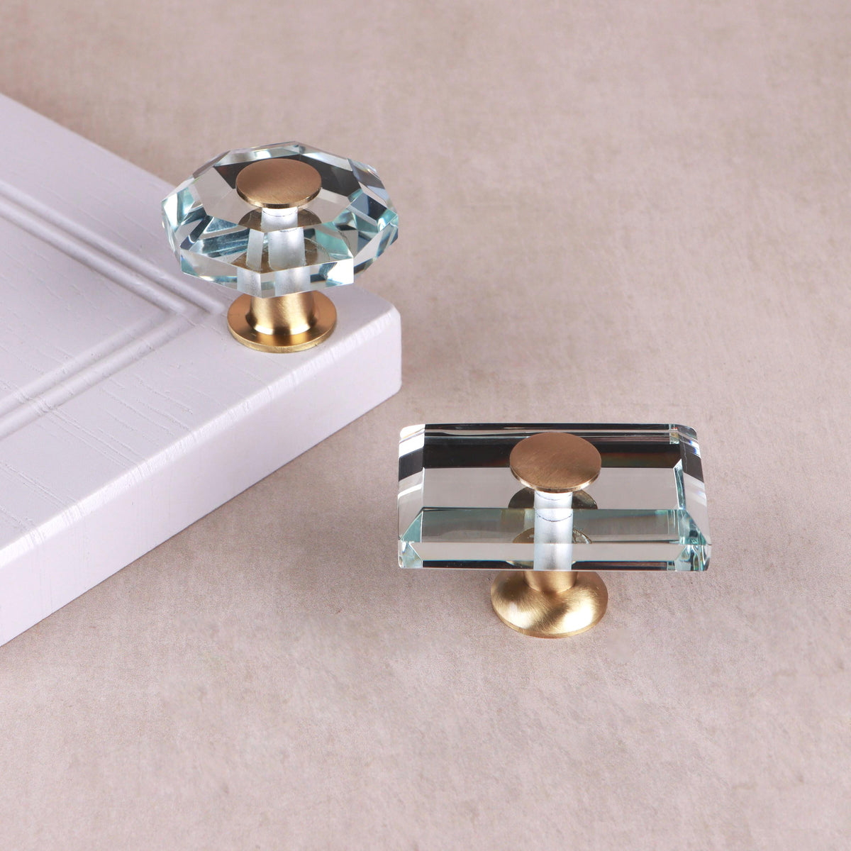 Clear crystal glass cabinet knobs on satin brass bases, in octagon and rectangle shapes