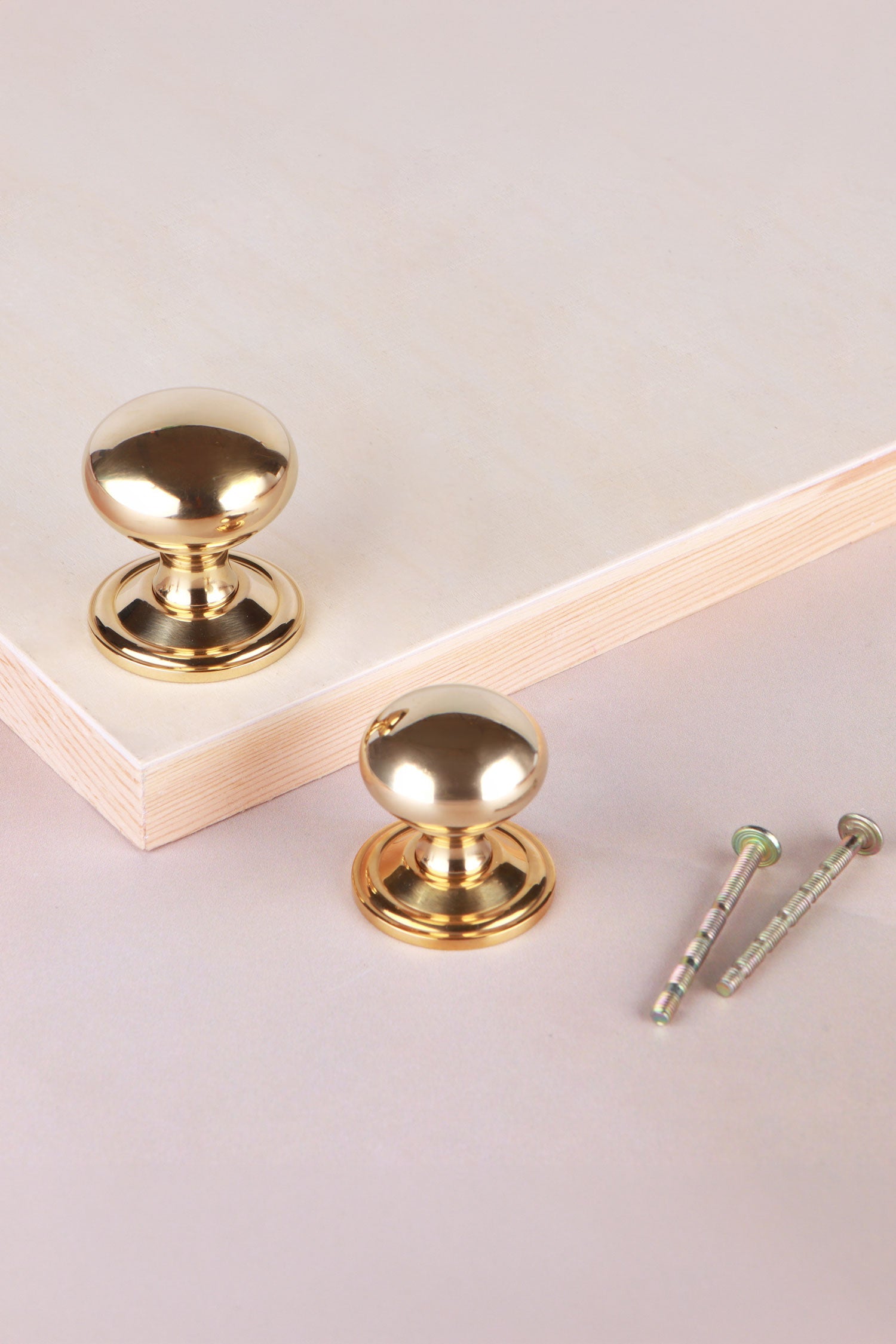 Bun cabinet knob in polished brass, shown in 32mm and 38mm