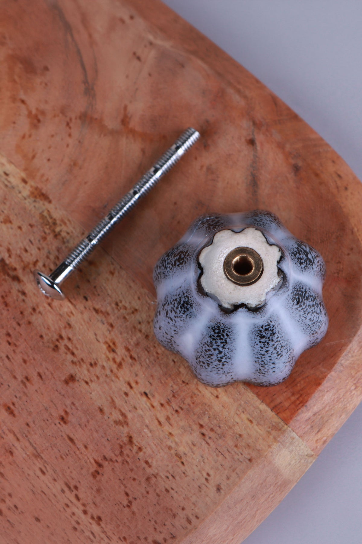 Underside of the black ceramic knob showing the threaded insert that takes the M4 bolt
