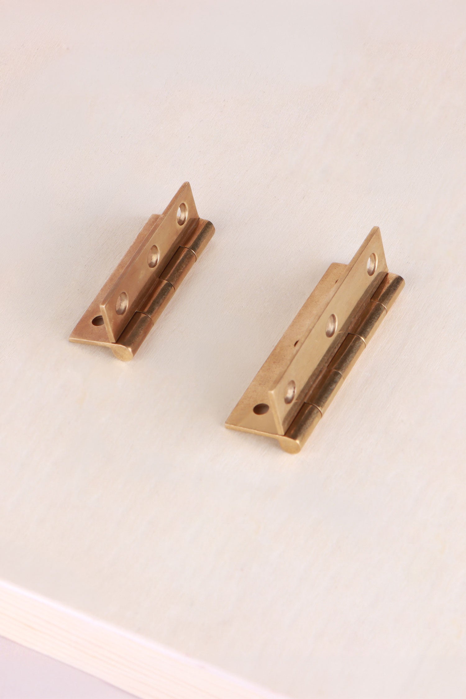 Aged brass butt hinge fitted to a cupboard door