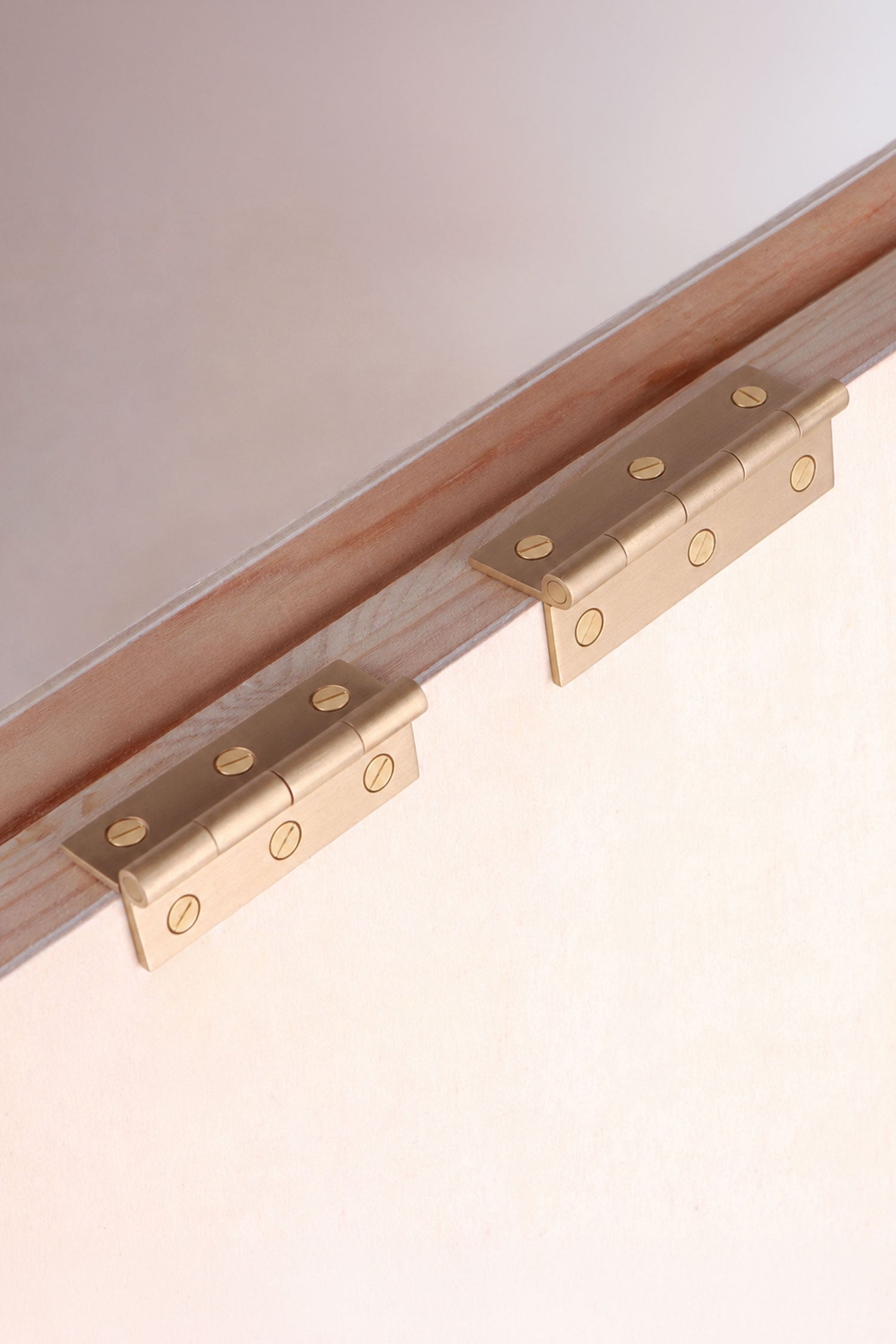 Cupboard butt hinge in satin brass, shown in both sizes