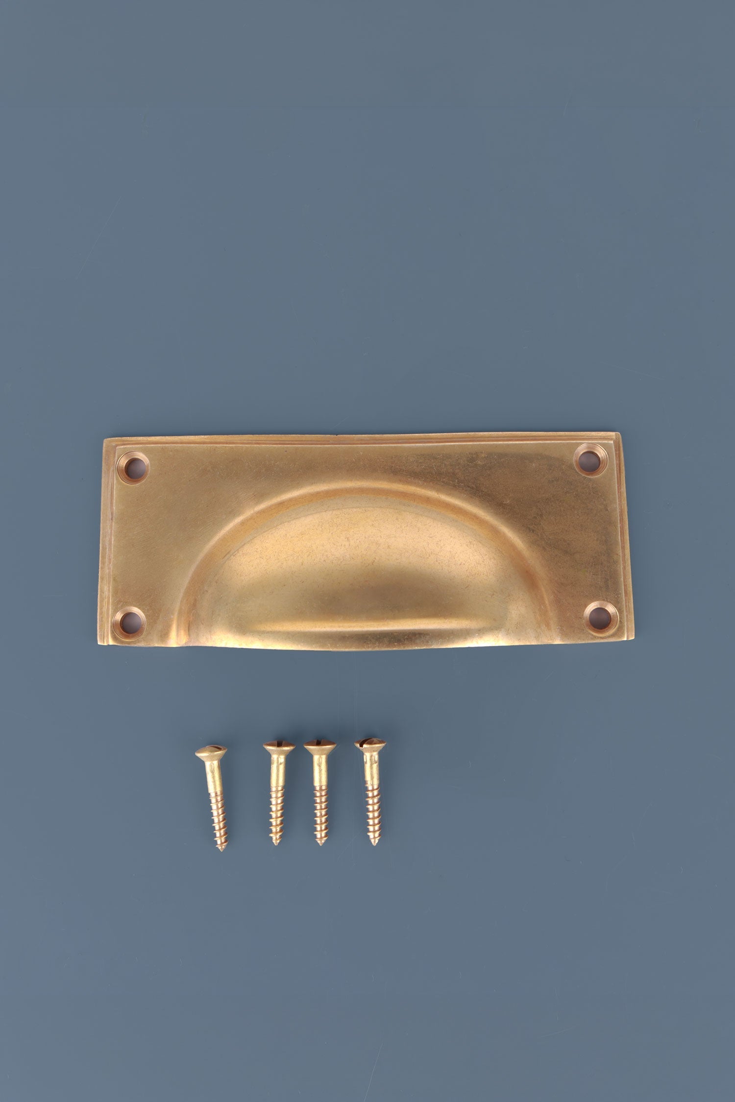 Rounded Plate cup pull in aged brass, unlacquered living finish