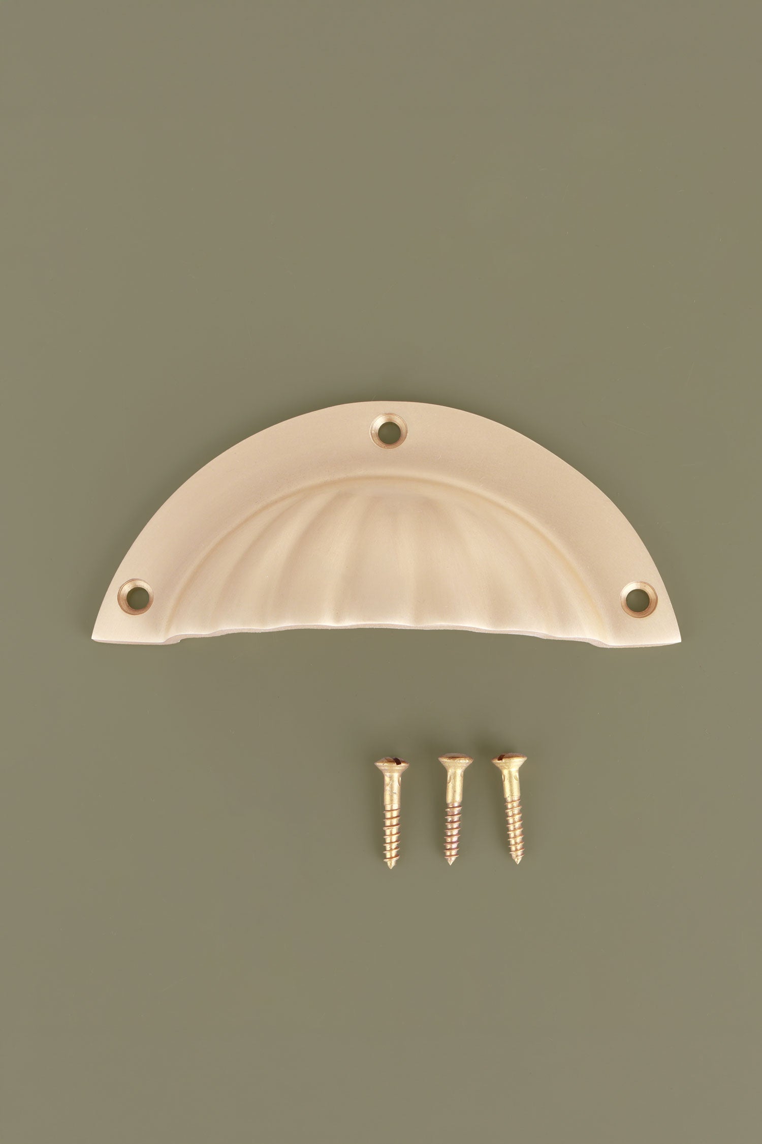 Fluted cup pull in satin brass, lacquered finish