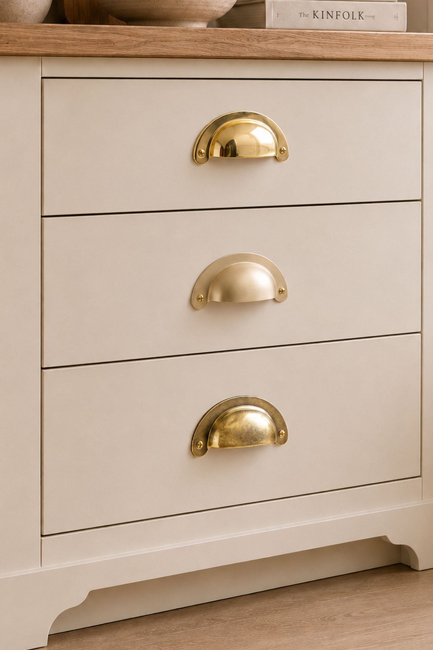 Three finishes of the Slim Crescent cup pull side by side