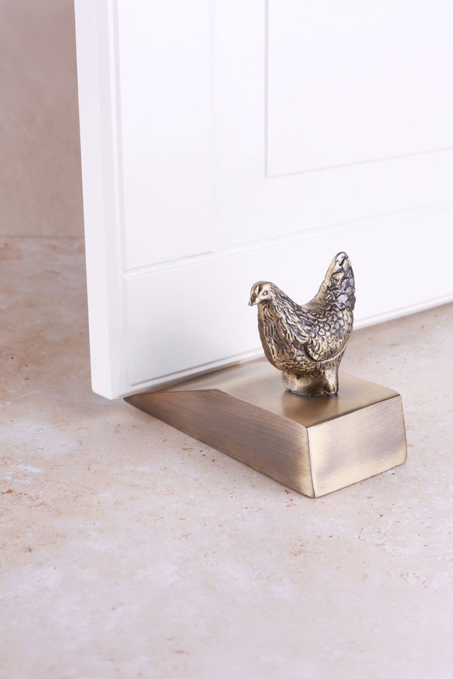 Hen door stopper in antique brass