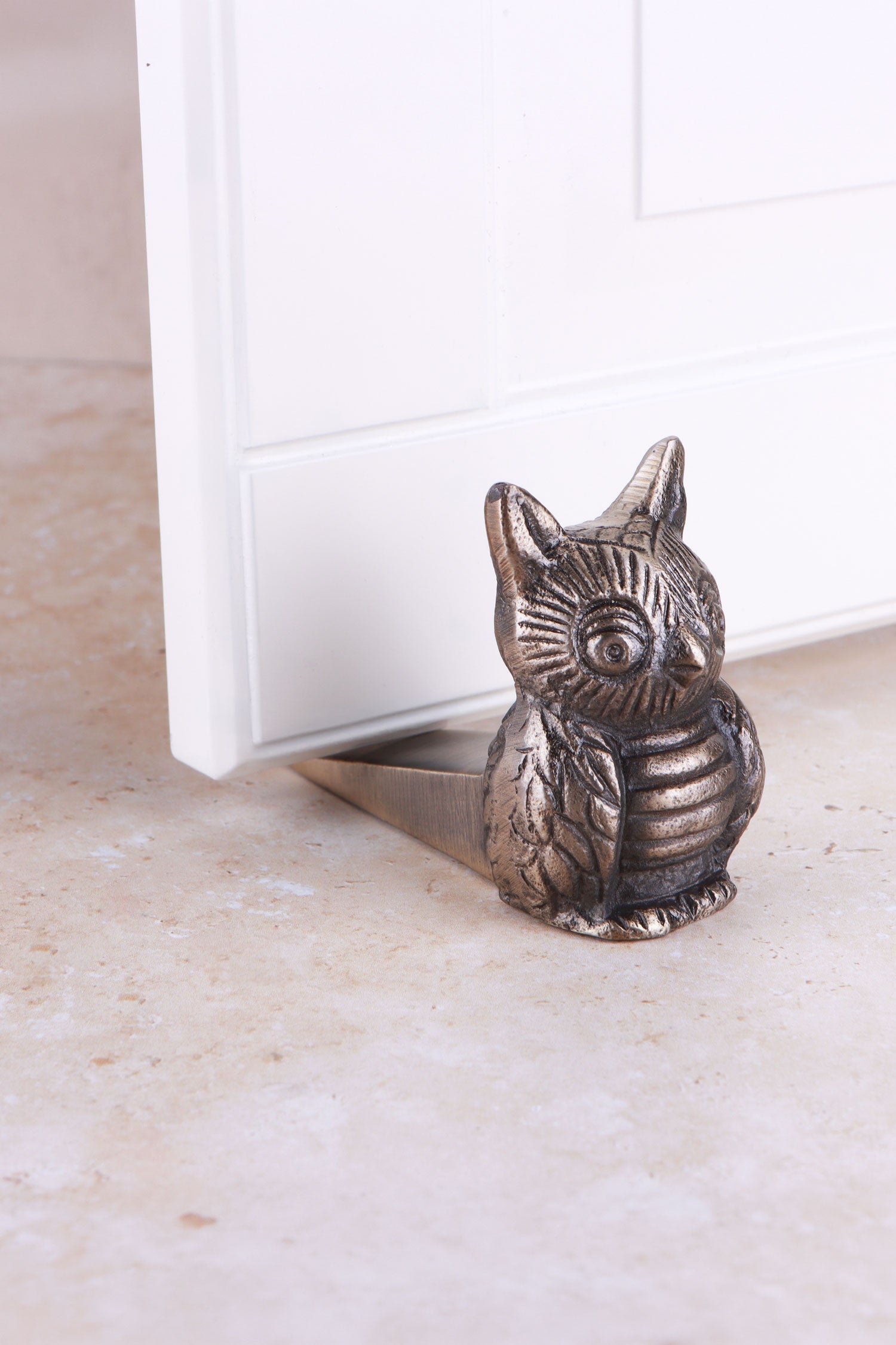 Owl door stopper in antique brass