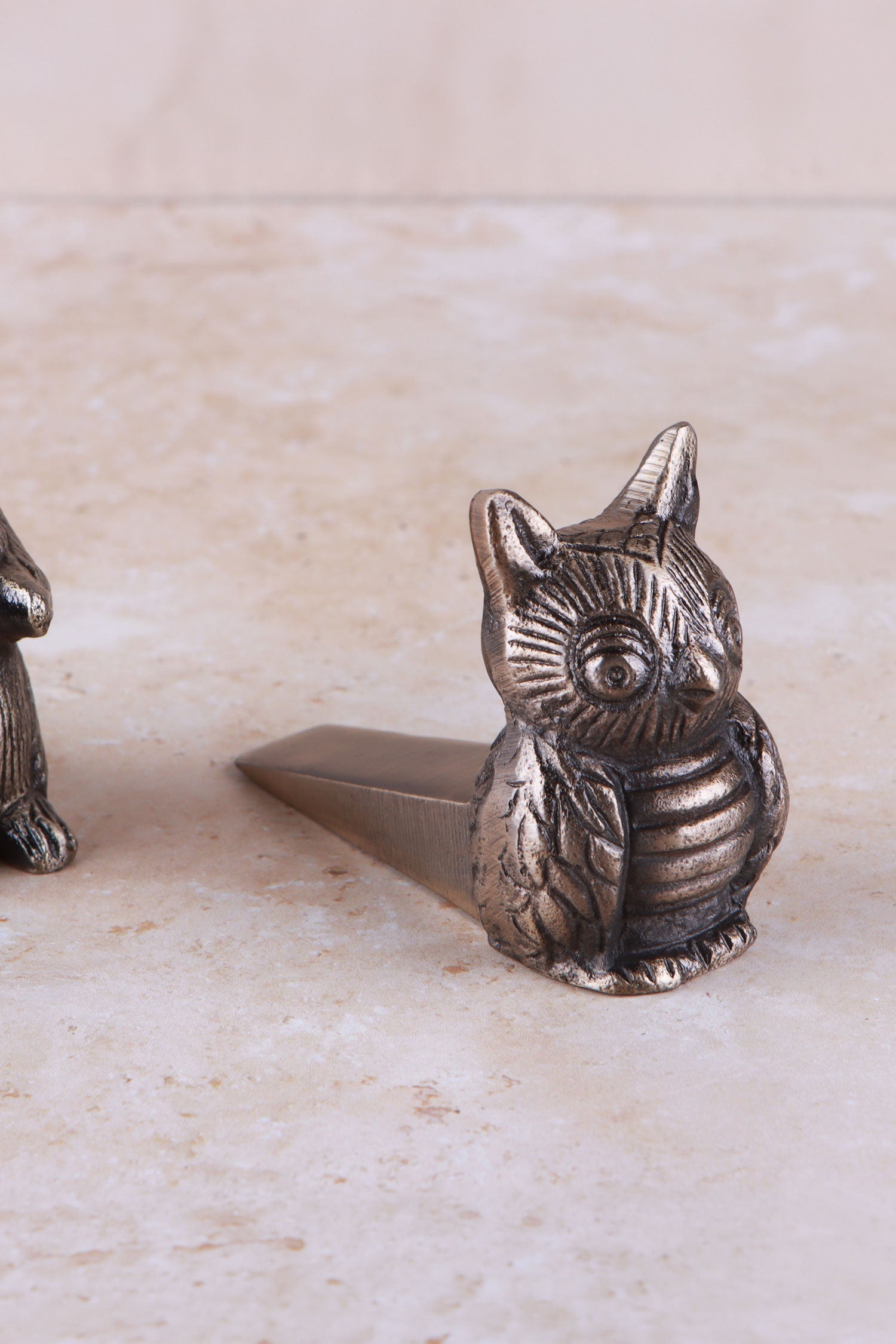 Owl door stopper in antique brass, side view