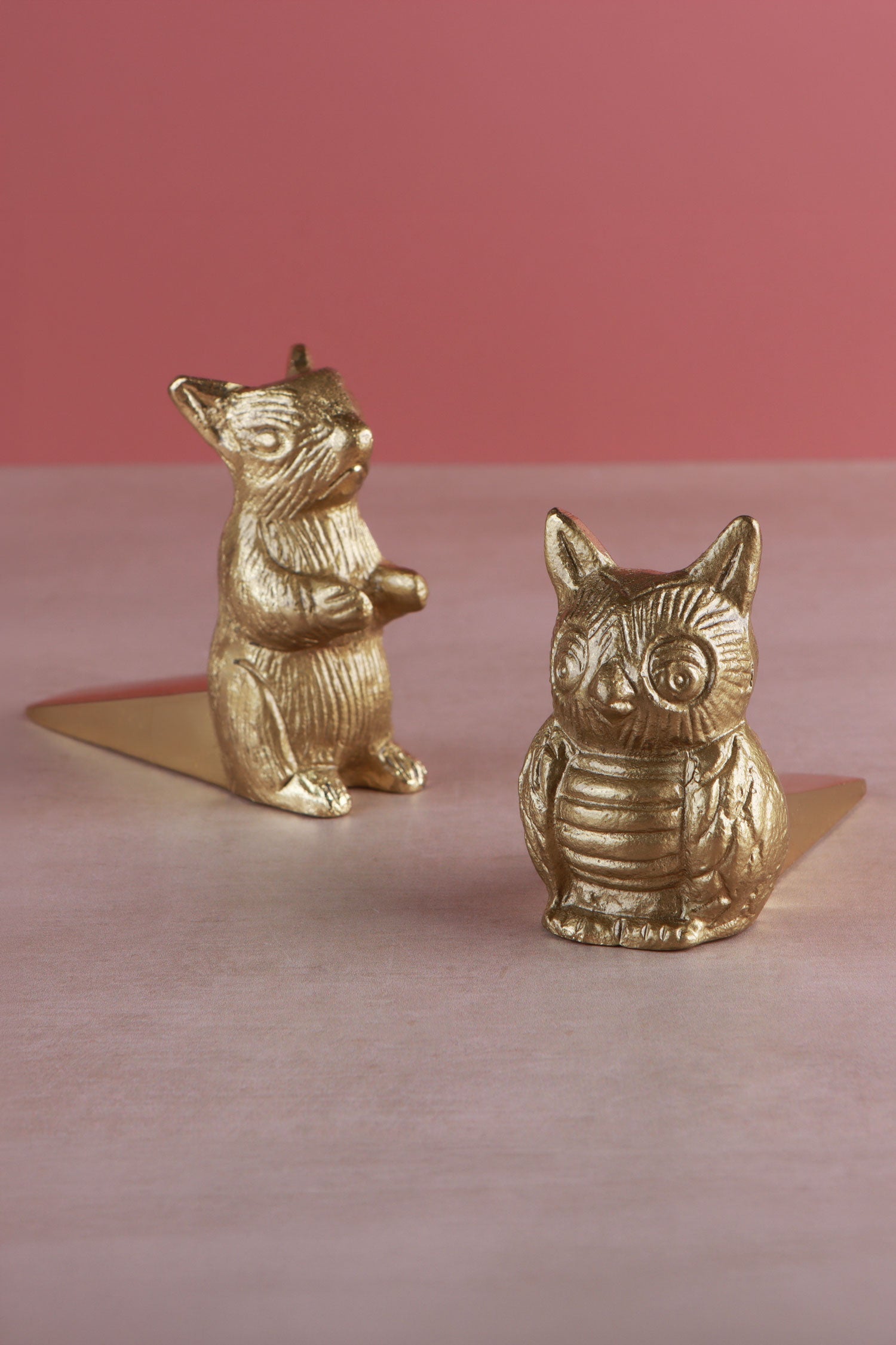 Owl and squirrel door stoppers together, polished brass