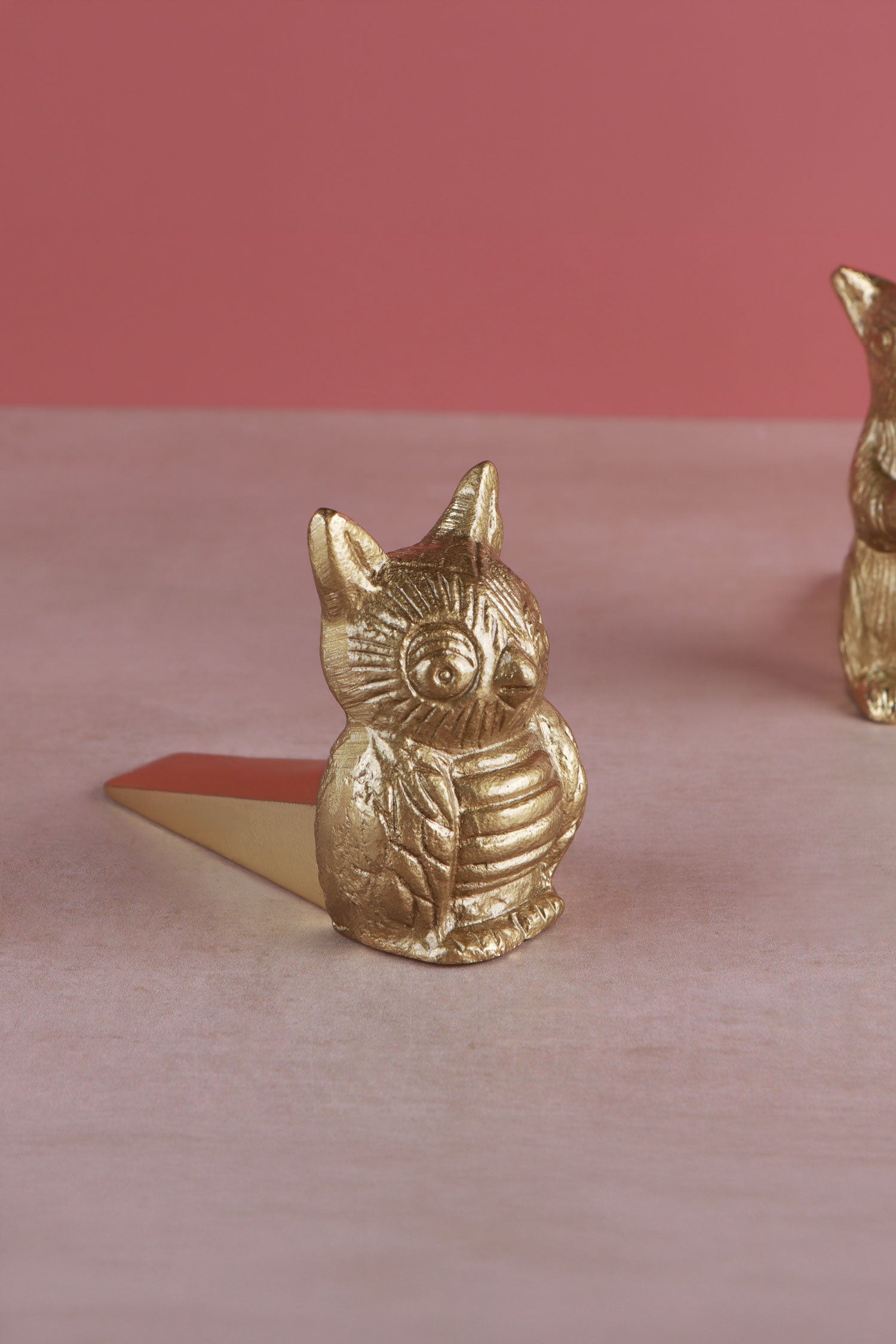 Owl door stopper in polished brass, side view