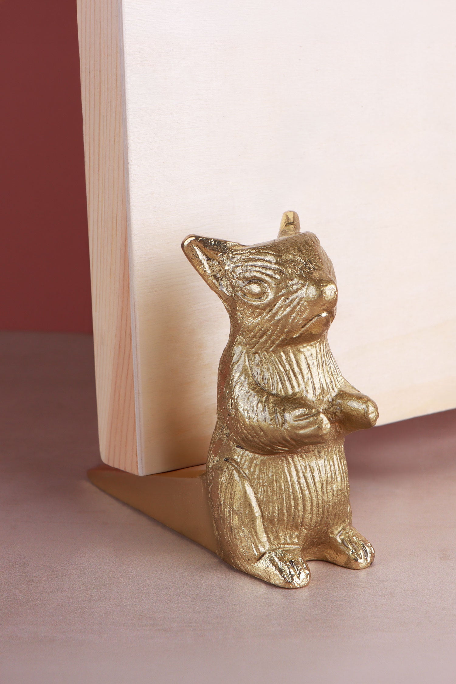 Squirrel door stopper in polished brass