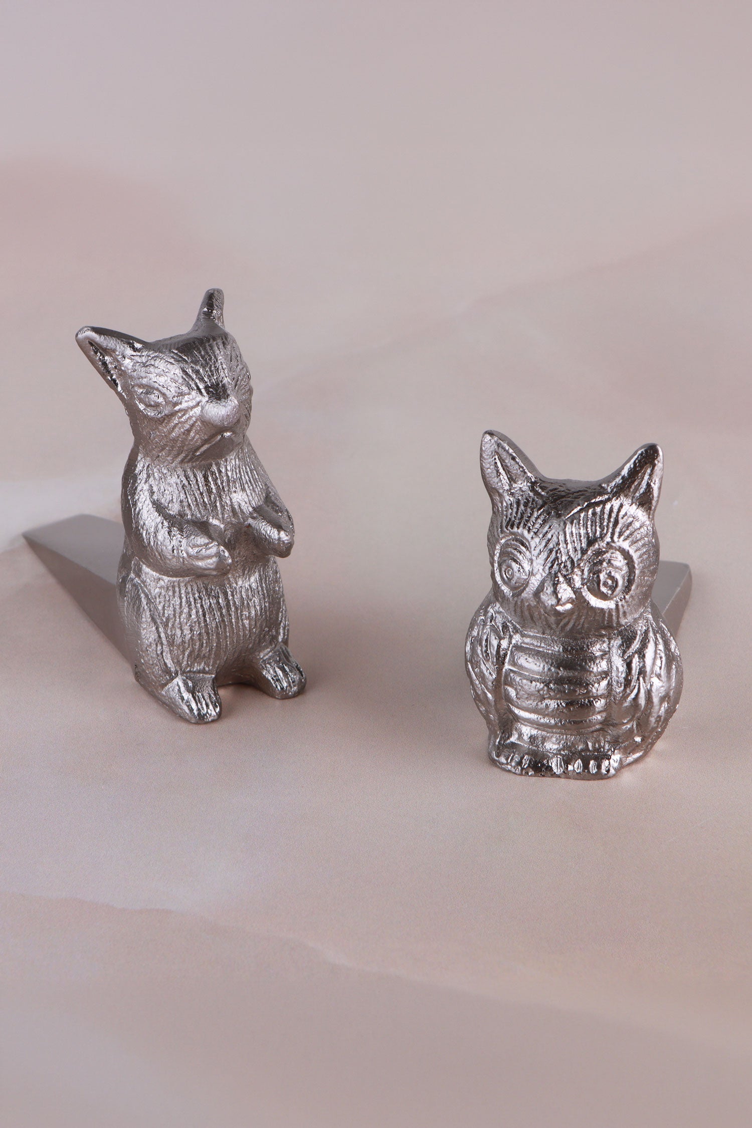 Owl and squirrel door stoppers together, chrome finish