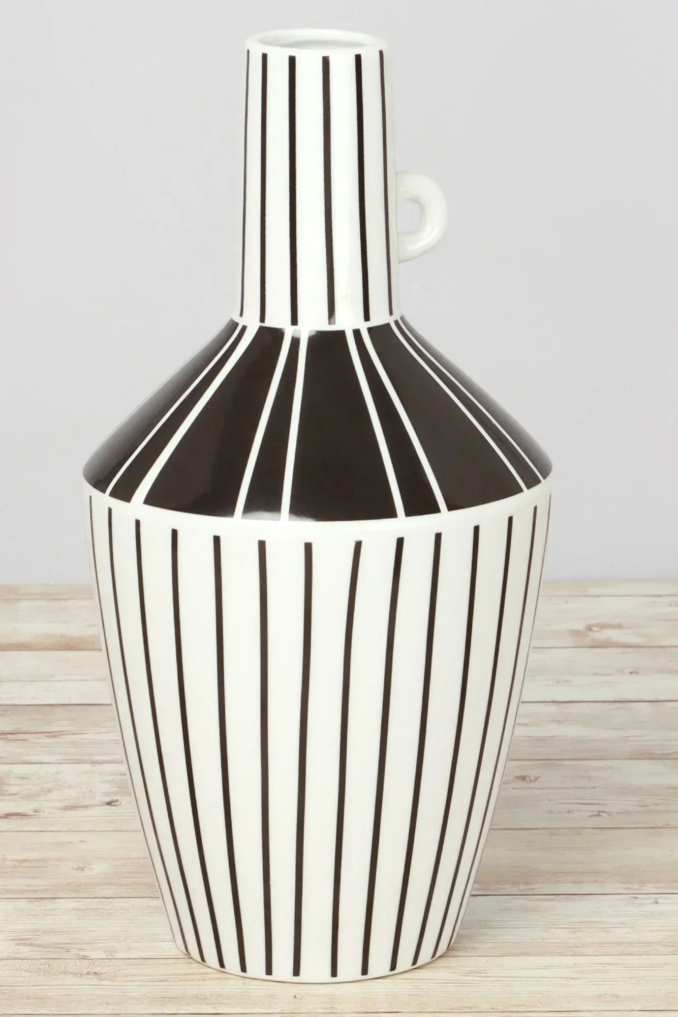 Black and white ceramic vase with vertical stripes on a wooden surface, G Decor home décor