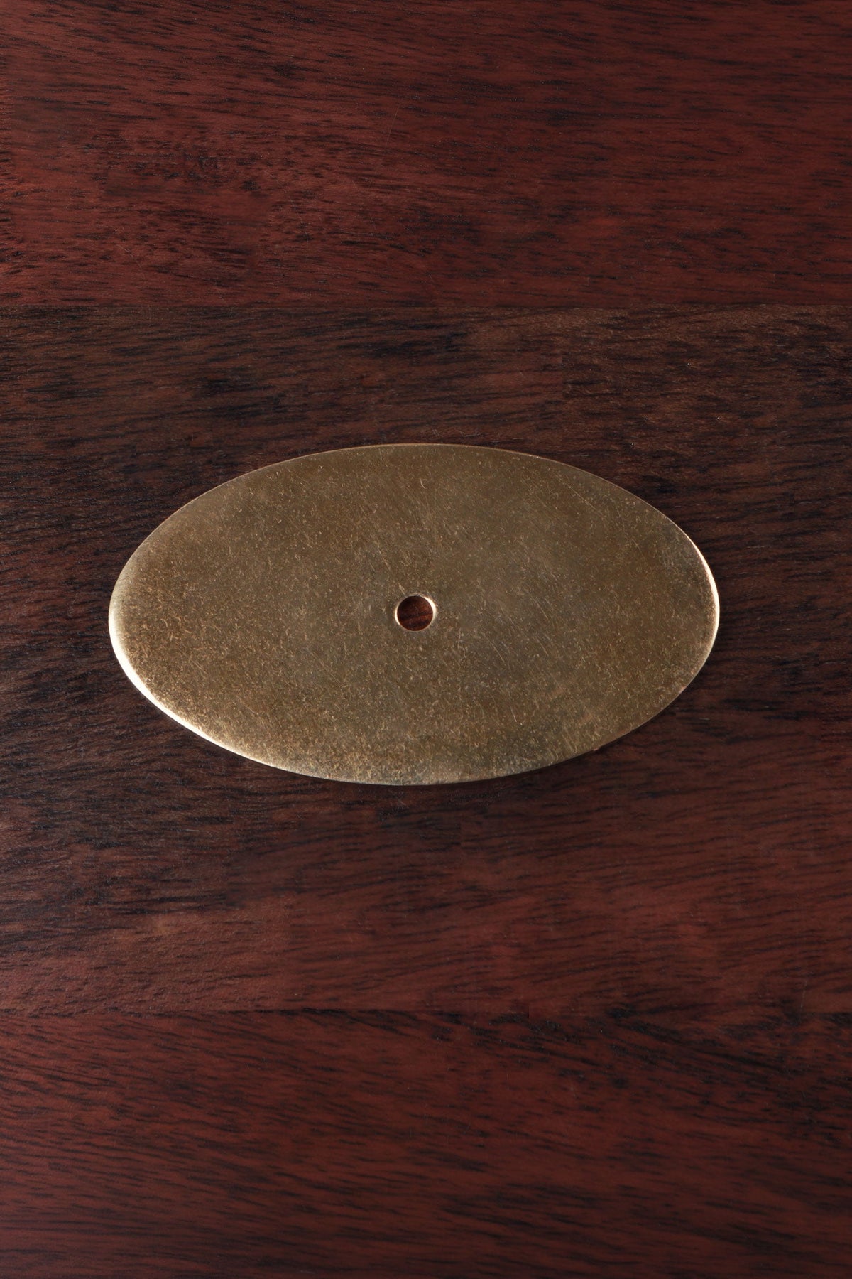 Oval aged brass backplate rosette, 70 by 40mm, with central fixing hole