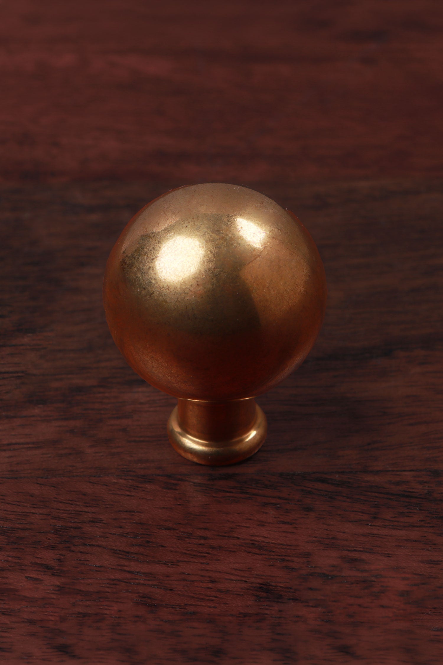 Ball cabinet knob in aged brass
