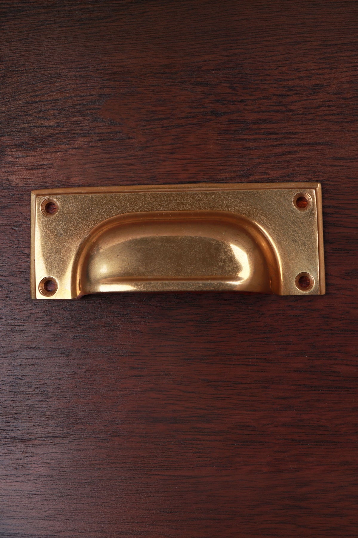 Bevelled plate aged brass cup pull, 4 inch, with a raised bevelled border