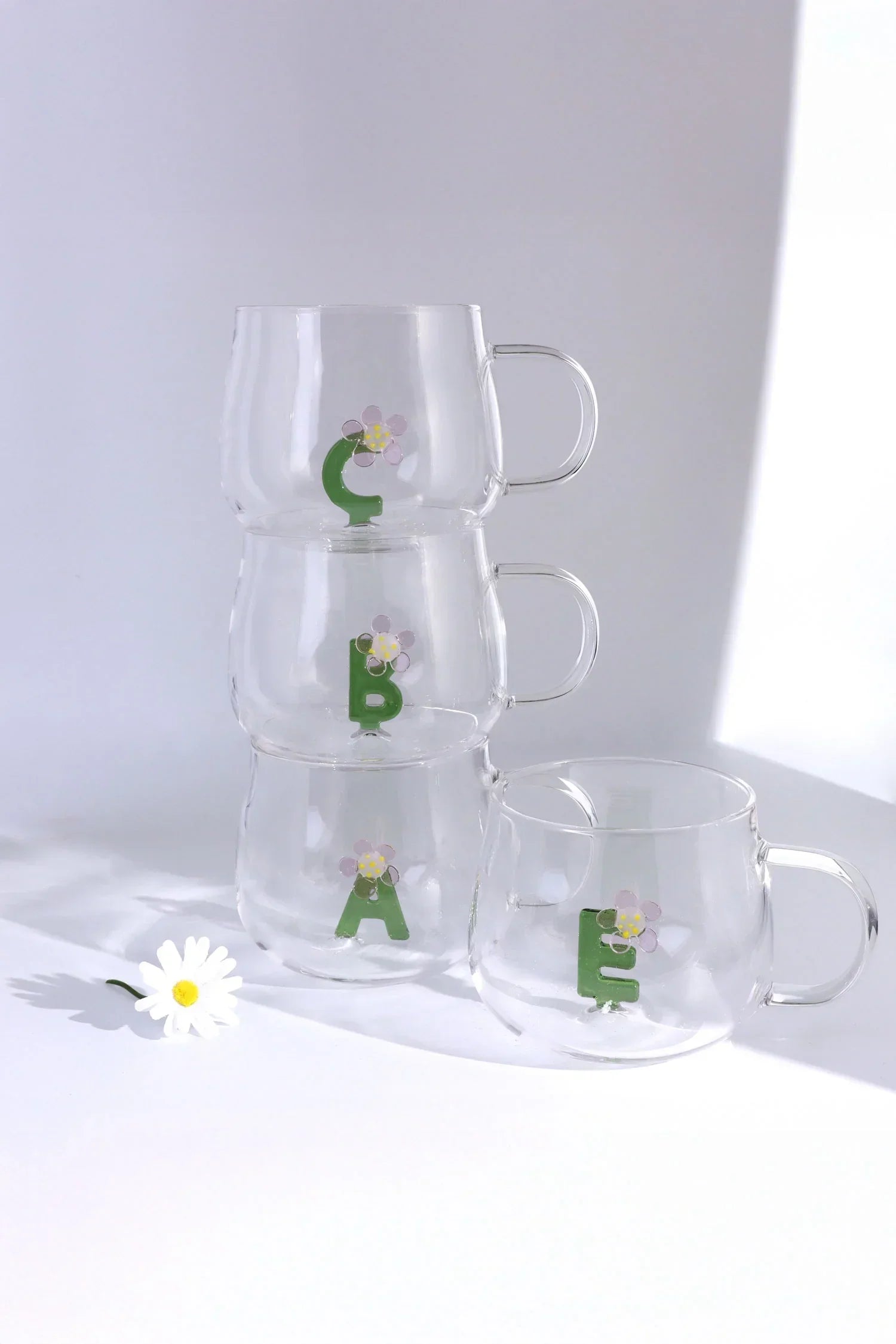 Set of clear glass mugs with floral letter designs on white background, G Decor luxury homeware