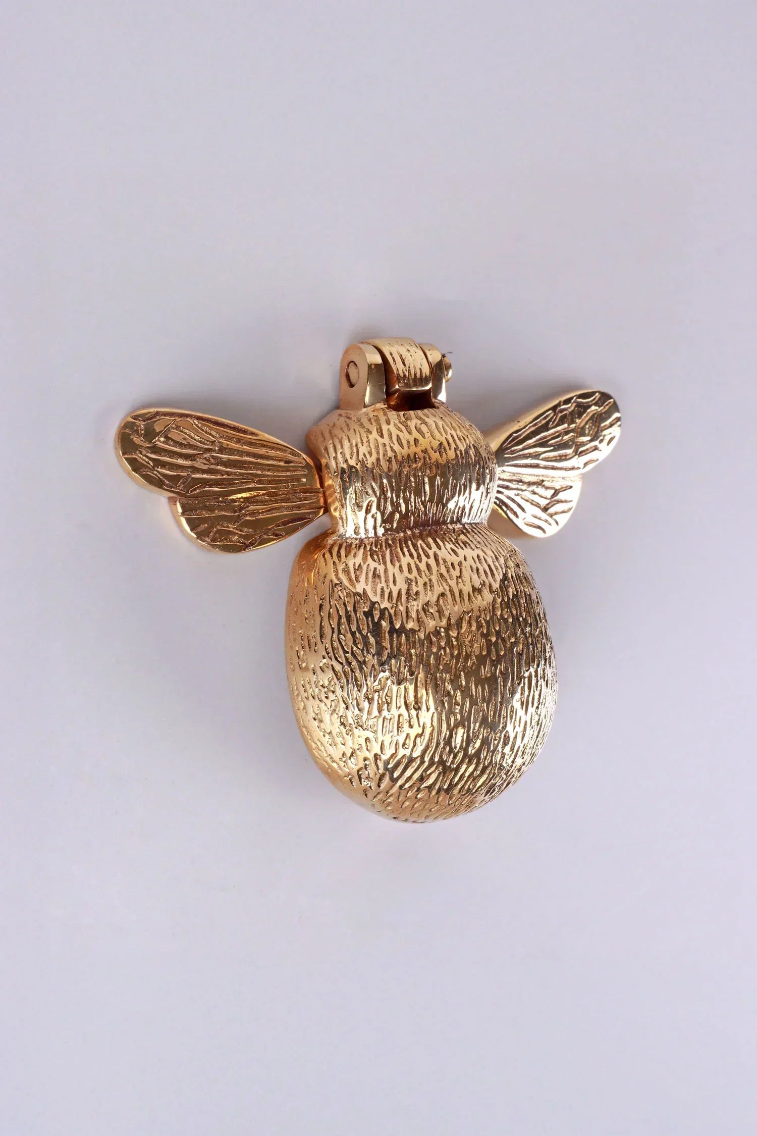 Gold bee-shaped luxury cabinet handle from G Decor on a plain background