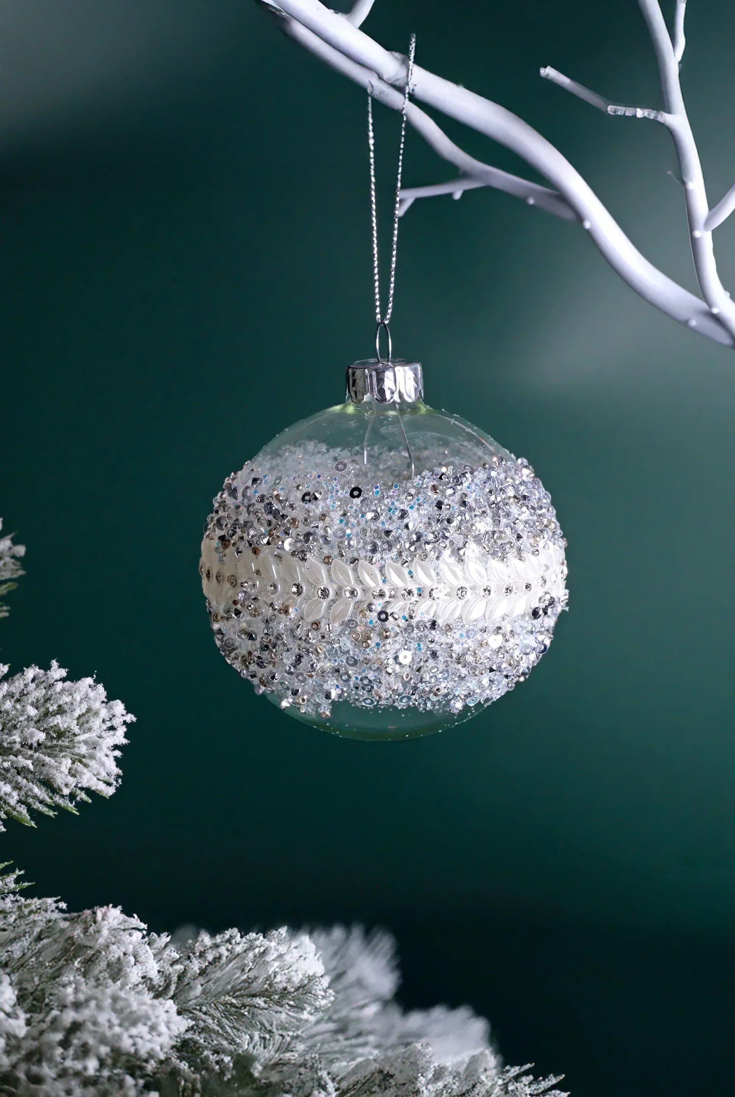 Luxury glass Christmas bauble with silver beaded decor on a frosted tree branch, G Decor