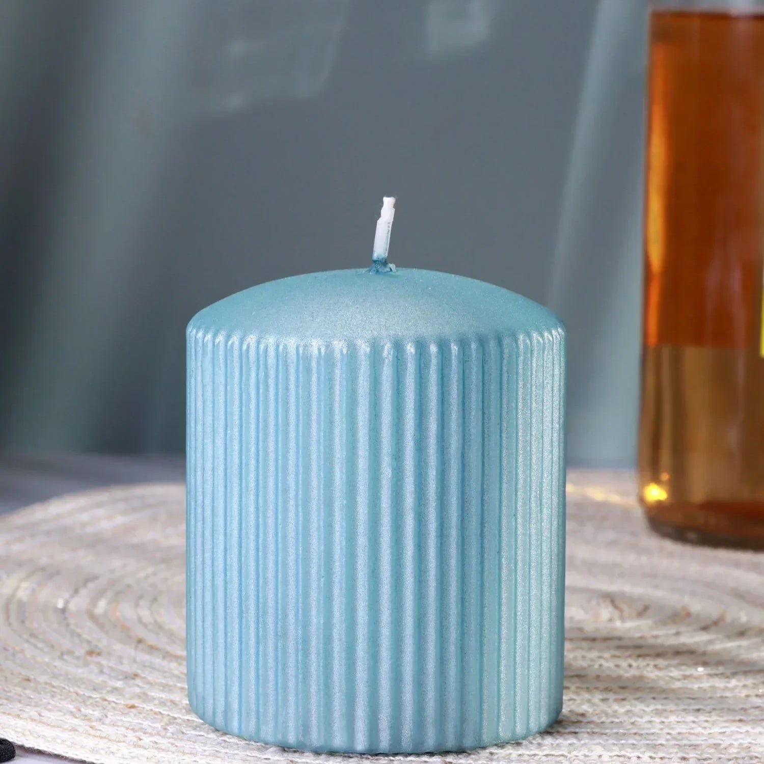 Blue ribbed pillar candle from G Decor on a woven placemat, luxury home décor accent