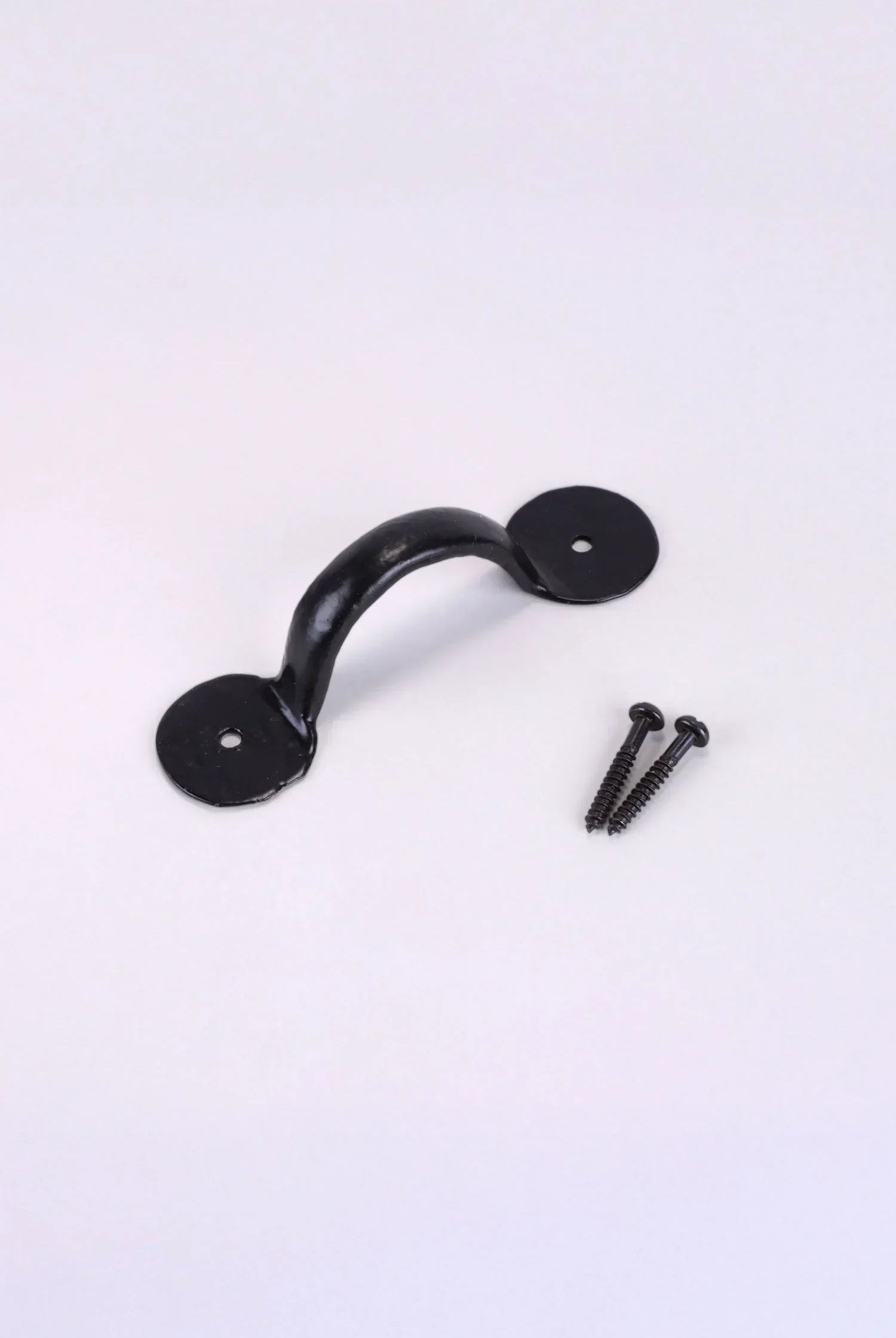 Black metal pull handle with two matching screws for kitchen or interior hardware by G Decor