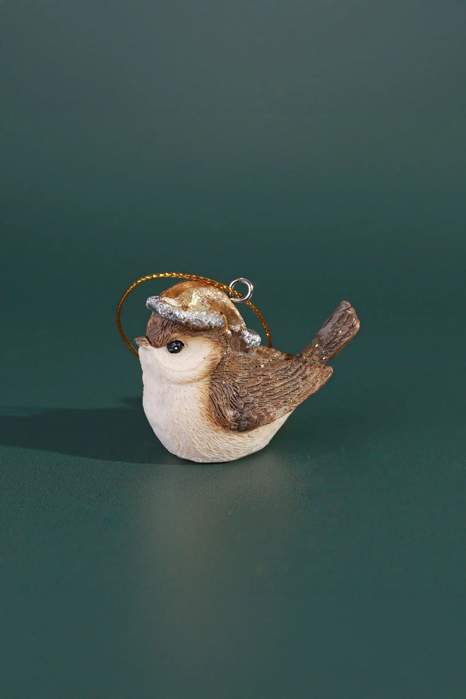 G Decor luxury bird ornament with gold hat for home décor, displayed on green background