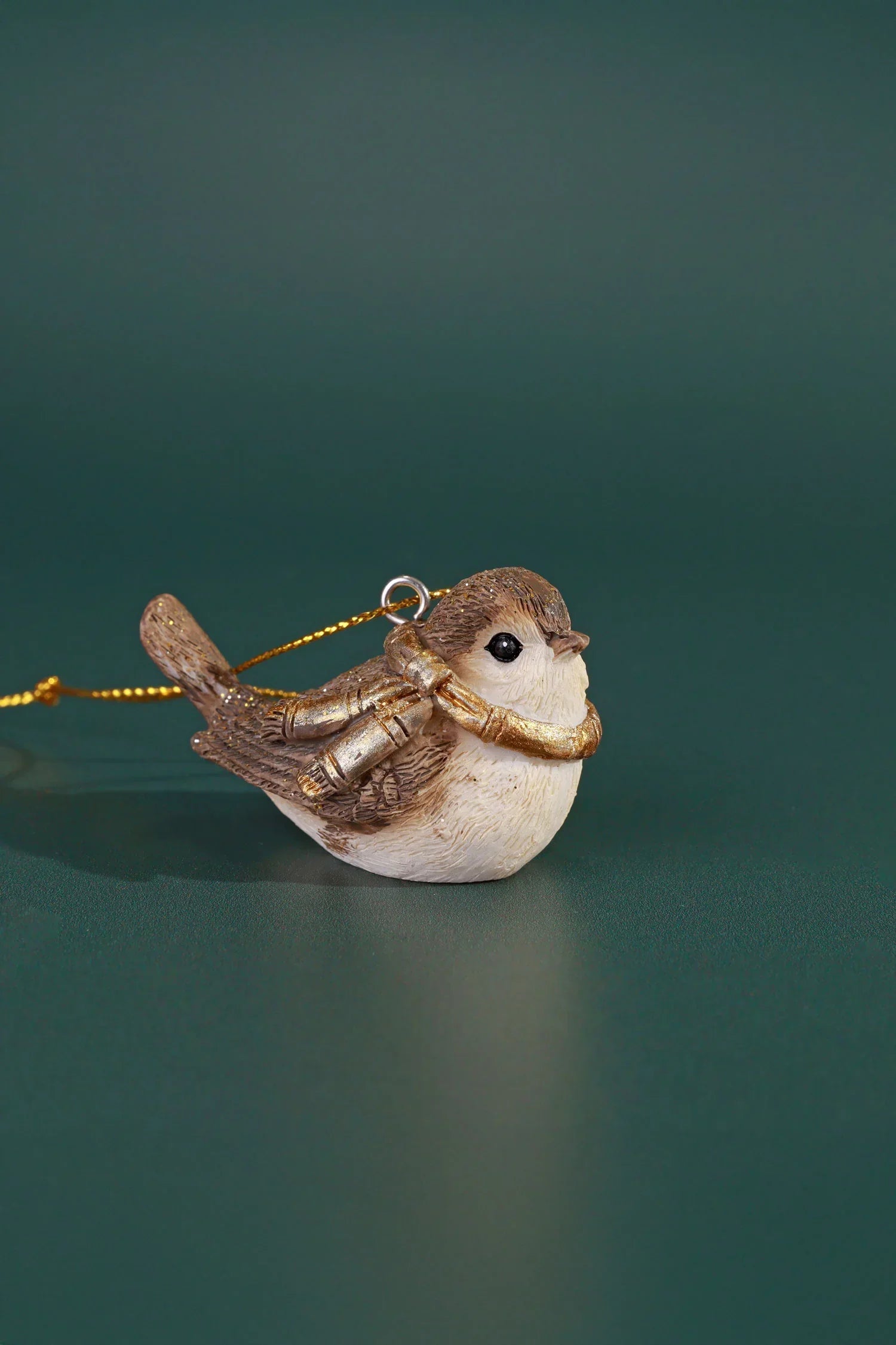 Gold and brown bird ornament with scarf on green background, G Decor luxury home décor