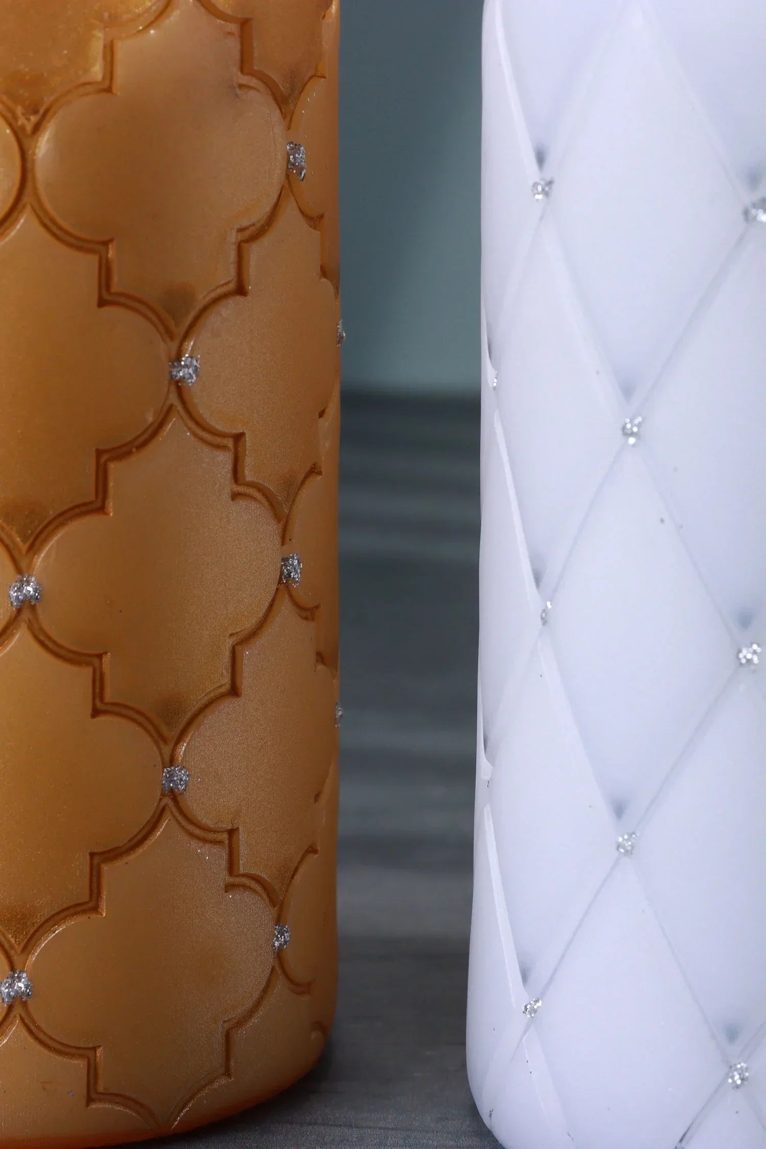 Close-up of luxury decorative candles with textured gold and white patterns, G Decor home décor.