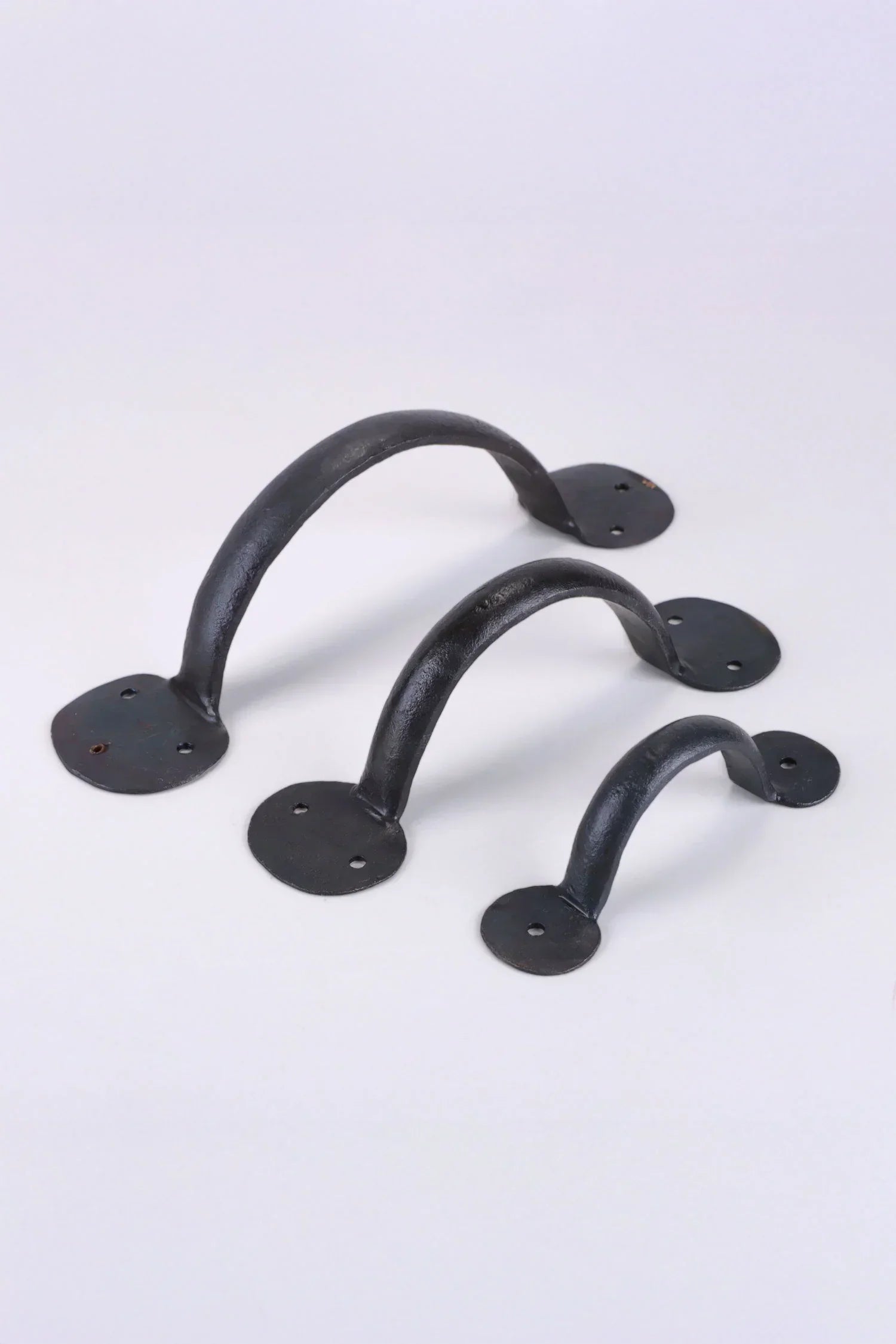 Set of three black iron cabinet handles from G Decor, shown on a white background