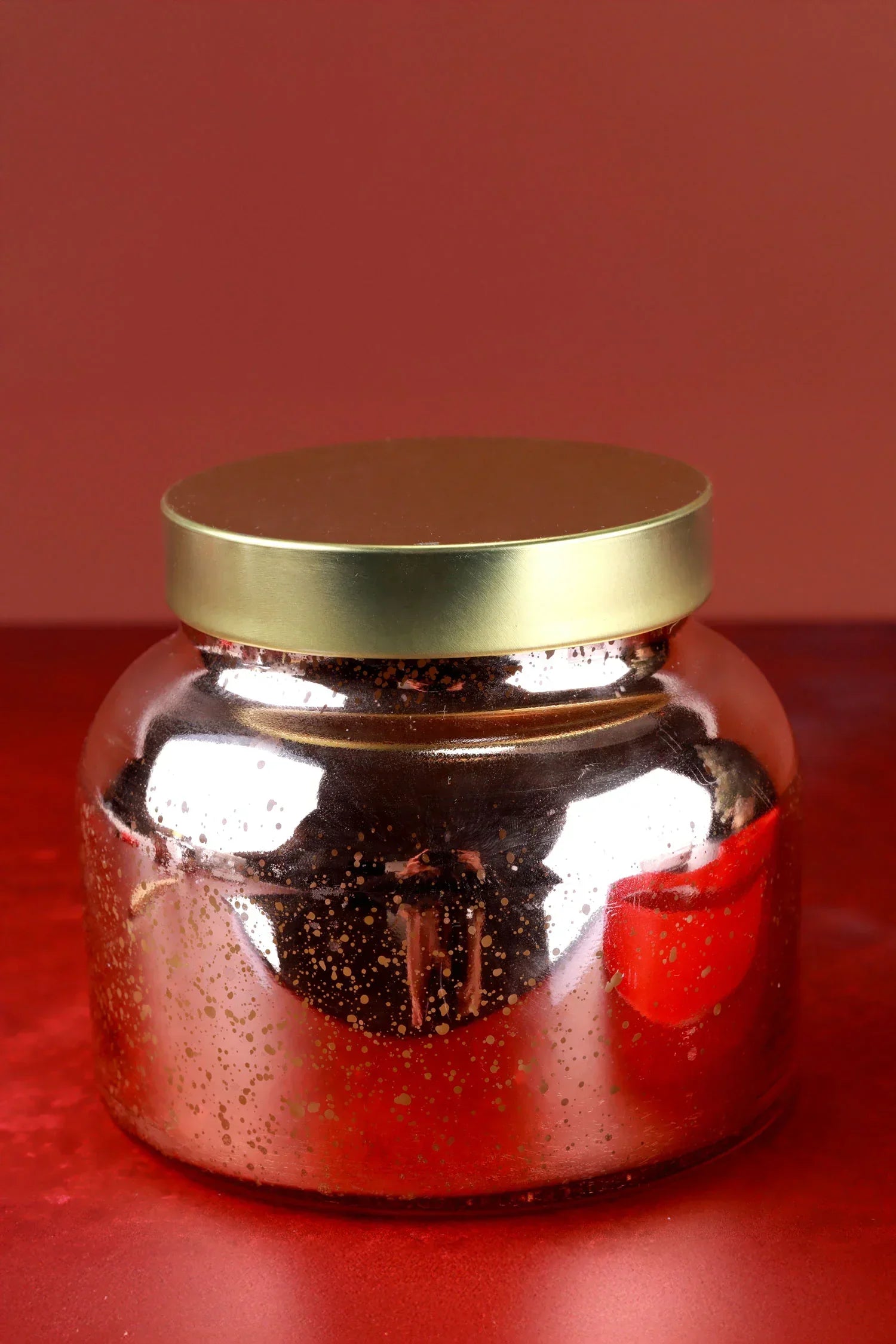 Luxury gold metallic jar candle on red background, G Decor home décor accessory