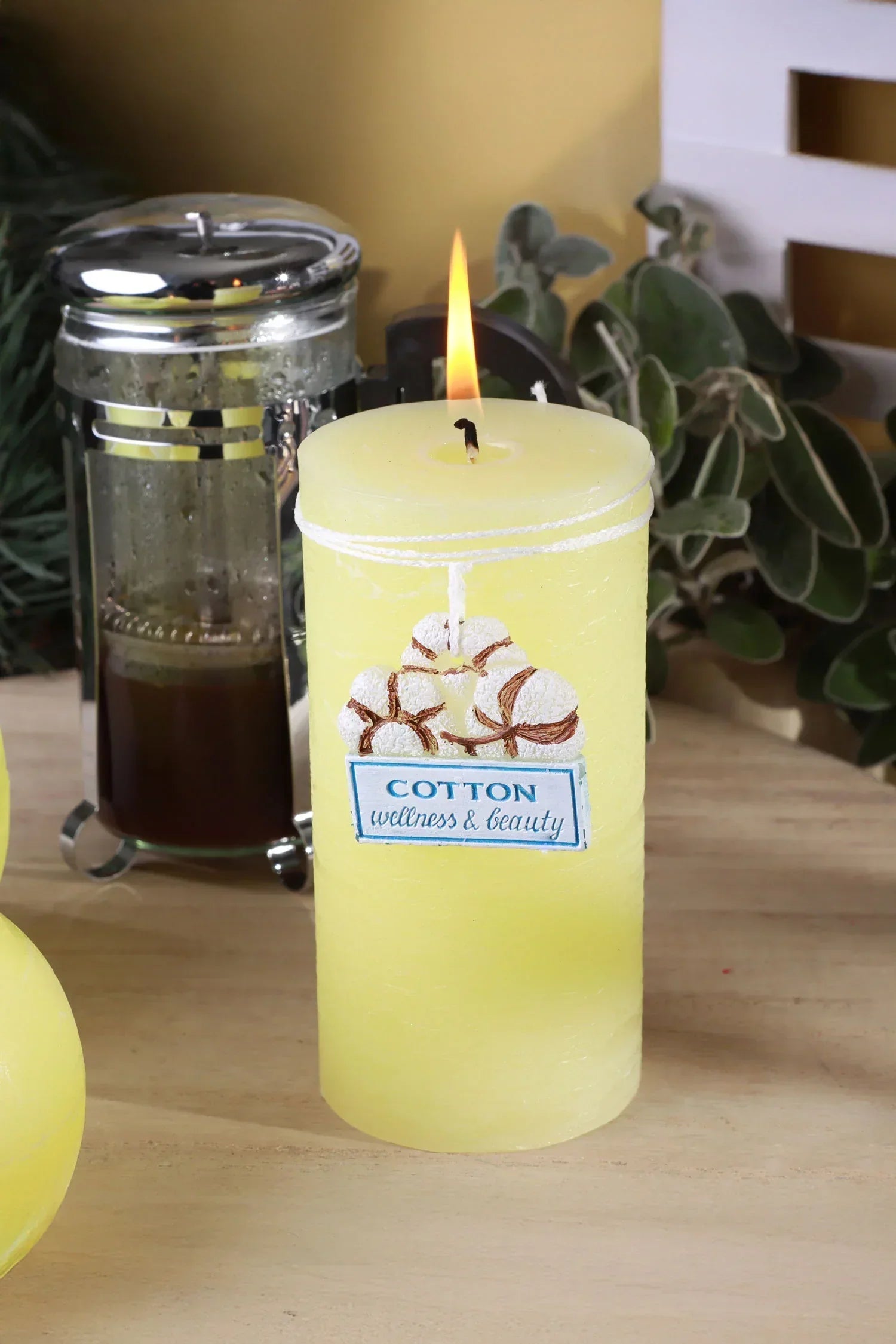Yellow cotton wellness and beauty candle burning on a wooden table, G Decor home décor