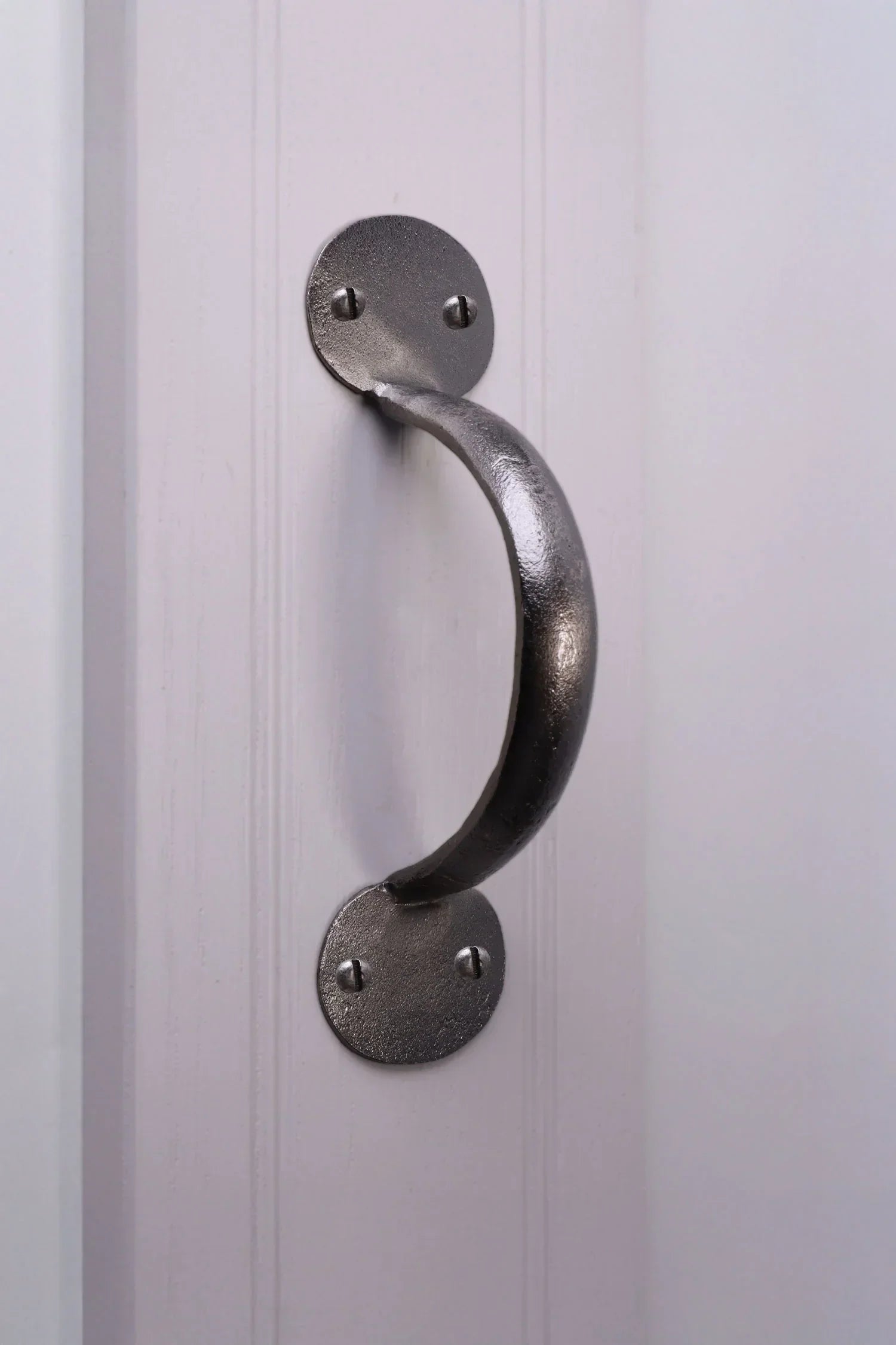 Brushed metal pull handle on white panel door, luxury hardware by G Decor.