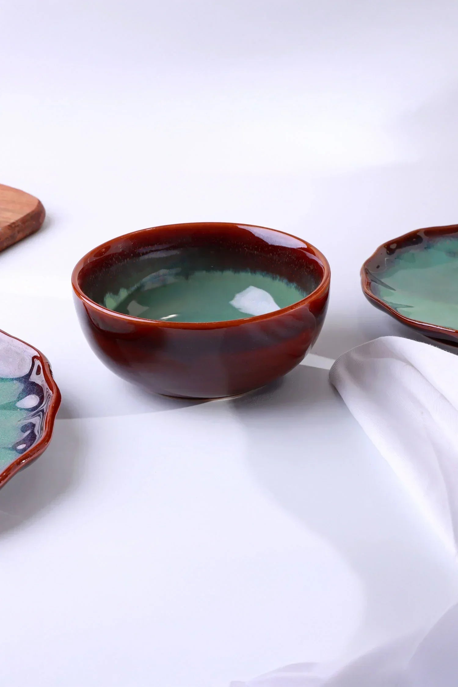 Luxury ceramic bowl and plates with green glaze from G Decor on white background