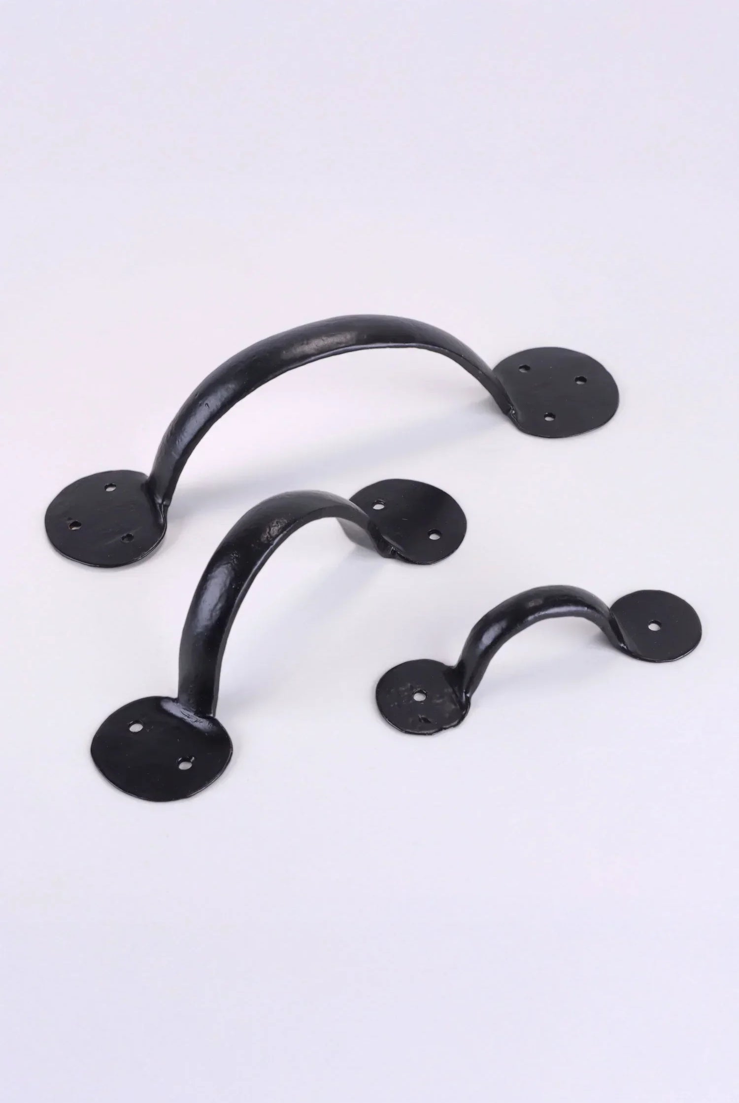 Set of three black metal cabinet handles by G Decor on a white background, luxury hardware