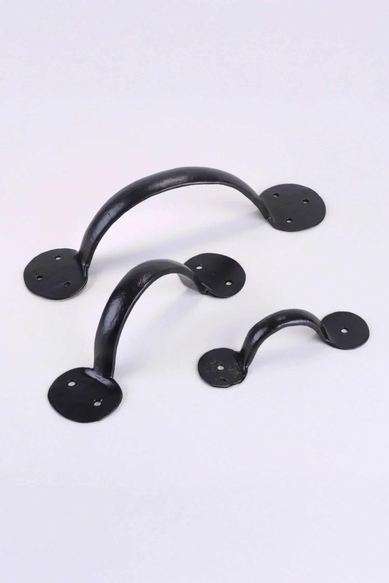 Set of three black metal cabinet handles by G Decor on a white background, luxury hardware