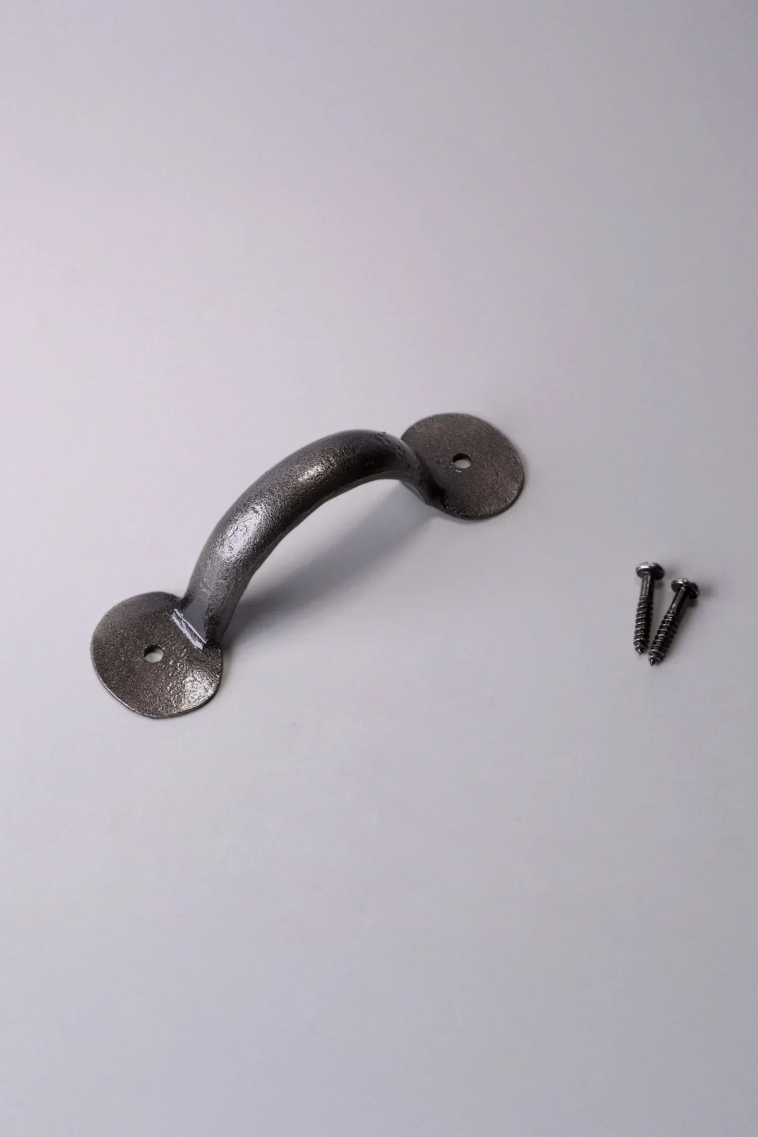 Metal cabinet pull handle with screws on a plain background, luxury hardware by G Decor