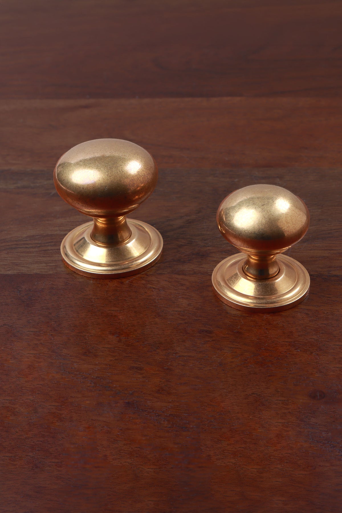 Aged brass bun cabinet knobs on stepped roses, 38mm and 32mm