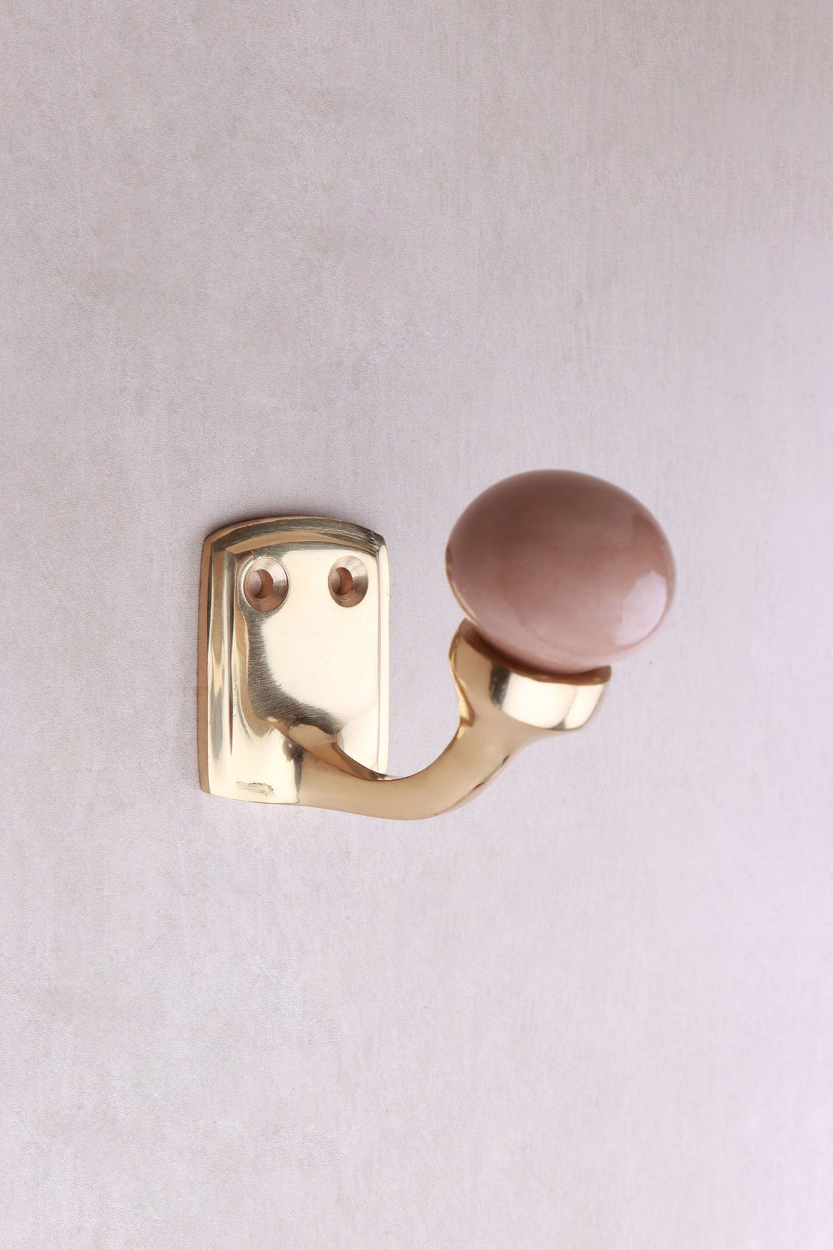 Brown ceramic ball hook: a brown ceramic ball on a curved brass-finish hook with a small back plate and two screws