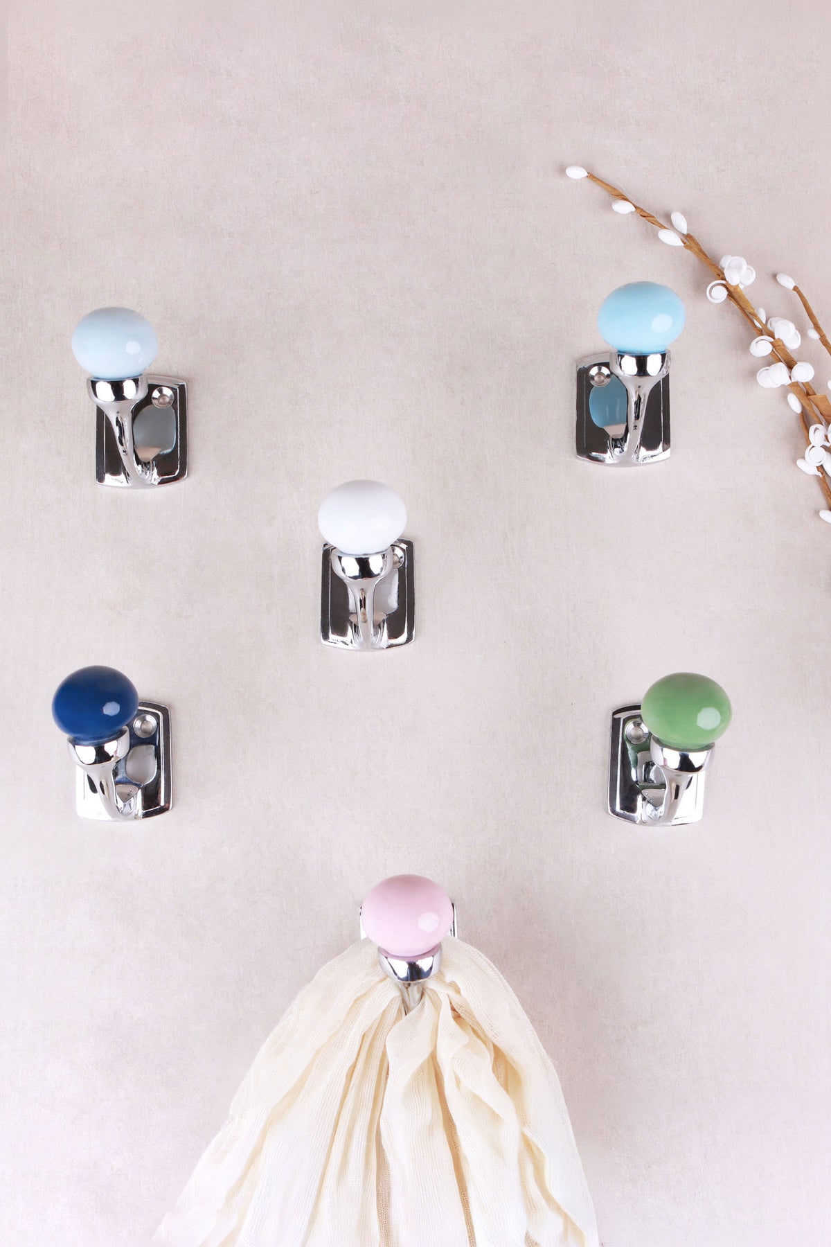 Chrome finish ceramic ball hooks in light grey, light blue, white, navy blue, sage green and light pink, seen from the front