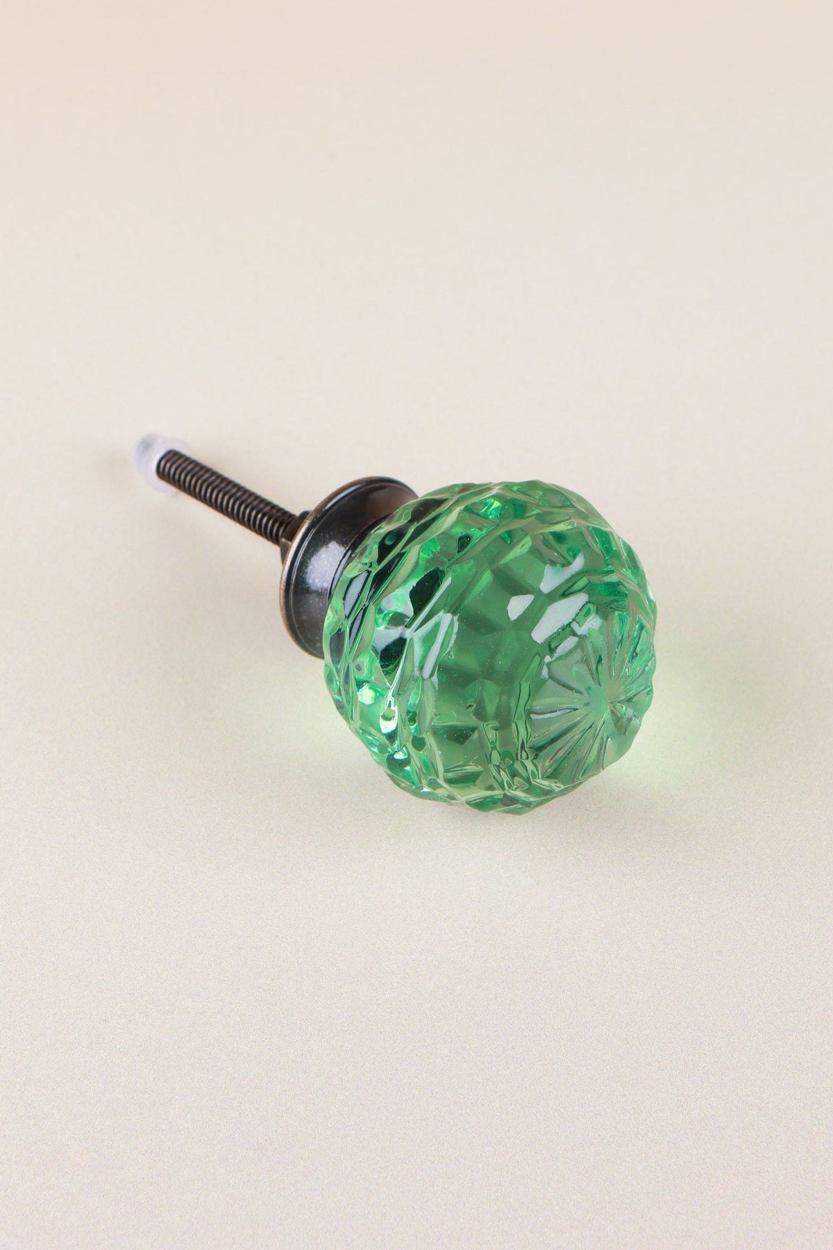 Light Green faceted glass ball cabinet knob, a bright fresh green, on an antique brass finish base with its fixing bolt