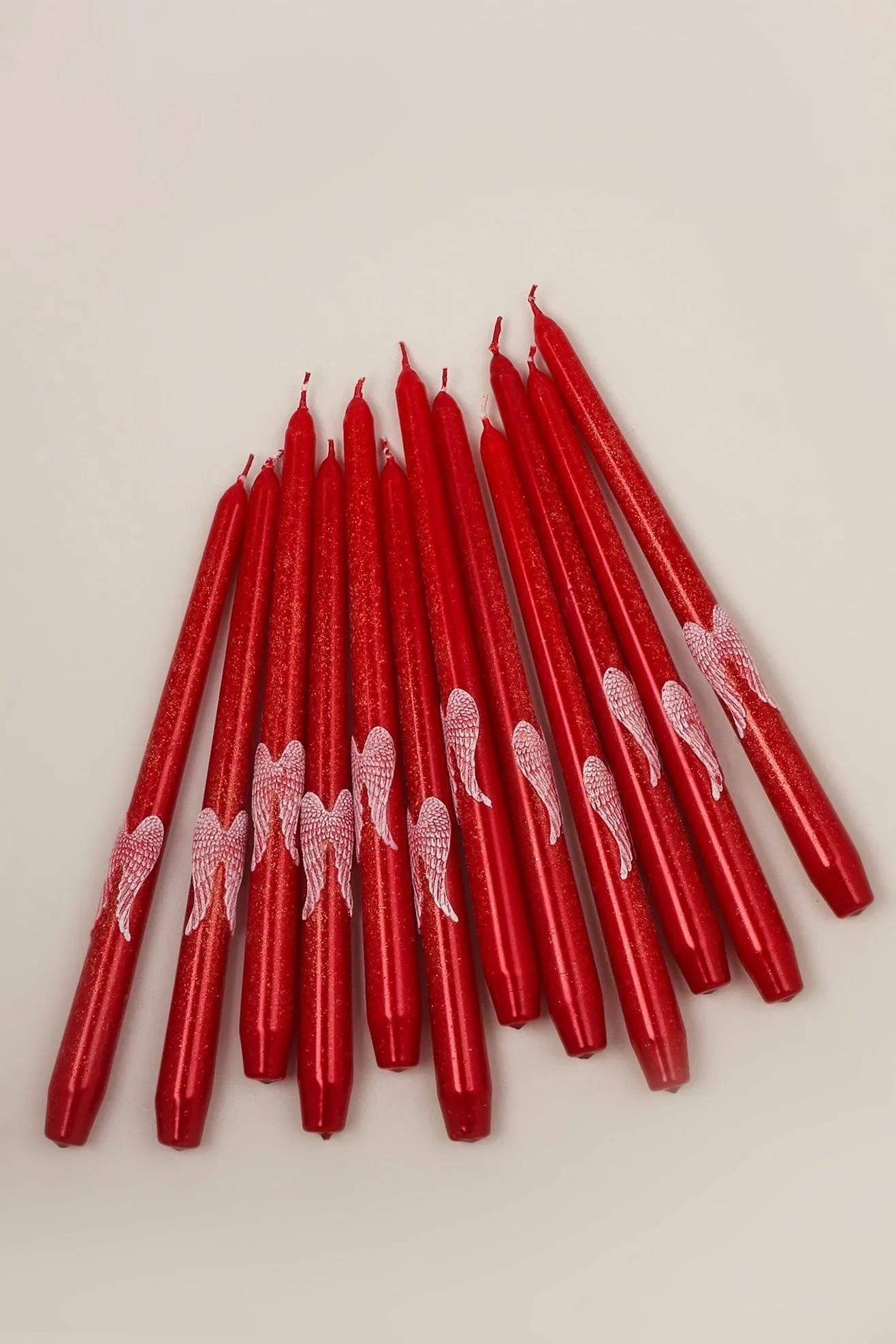 Featheré Wings Pair of Red Wax Taper Candles with Angel Wing Detail — lifestyle view, G Decor