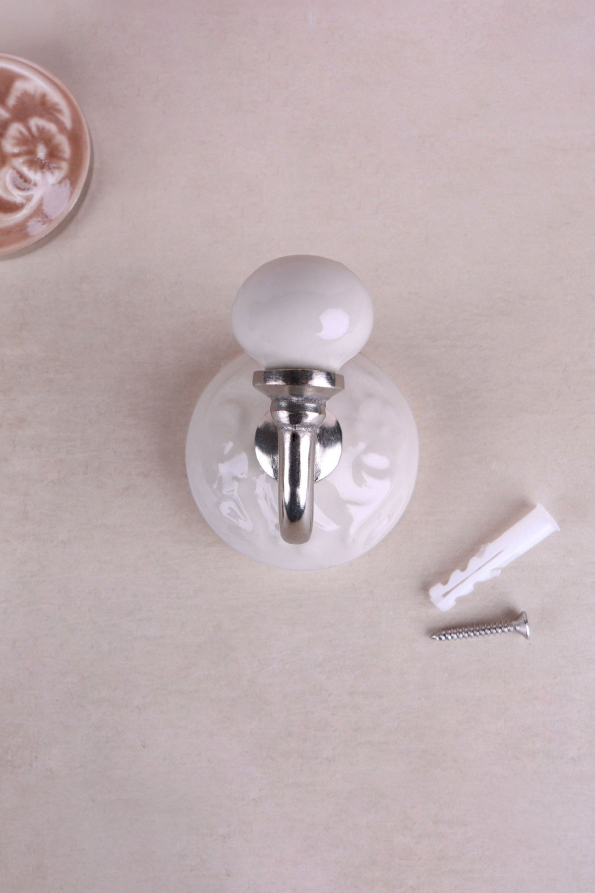 Cream floral ceramic wall hook with a chrome hook