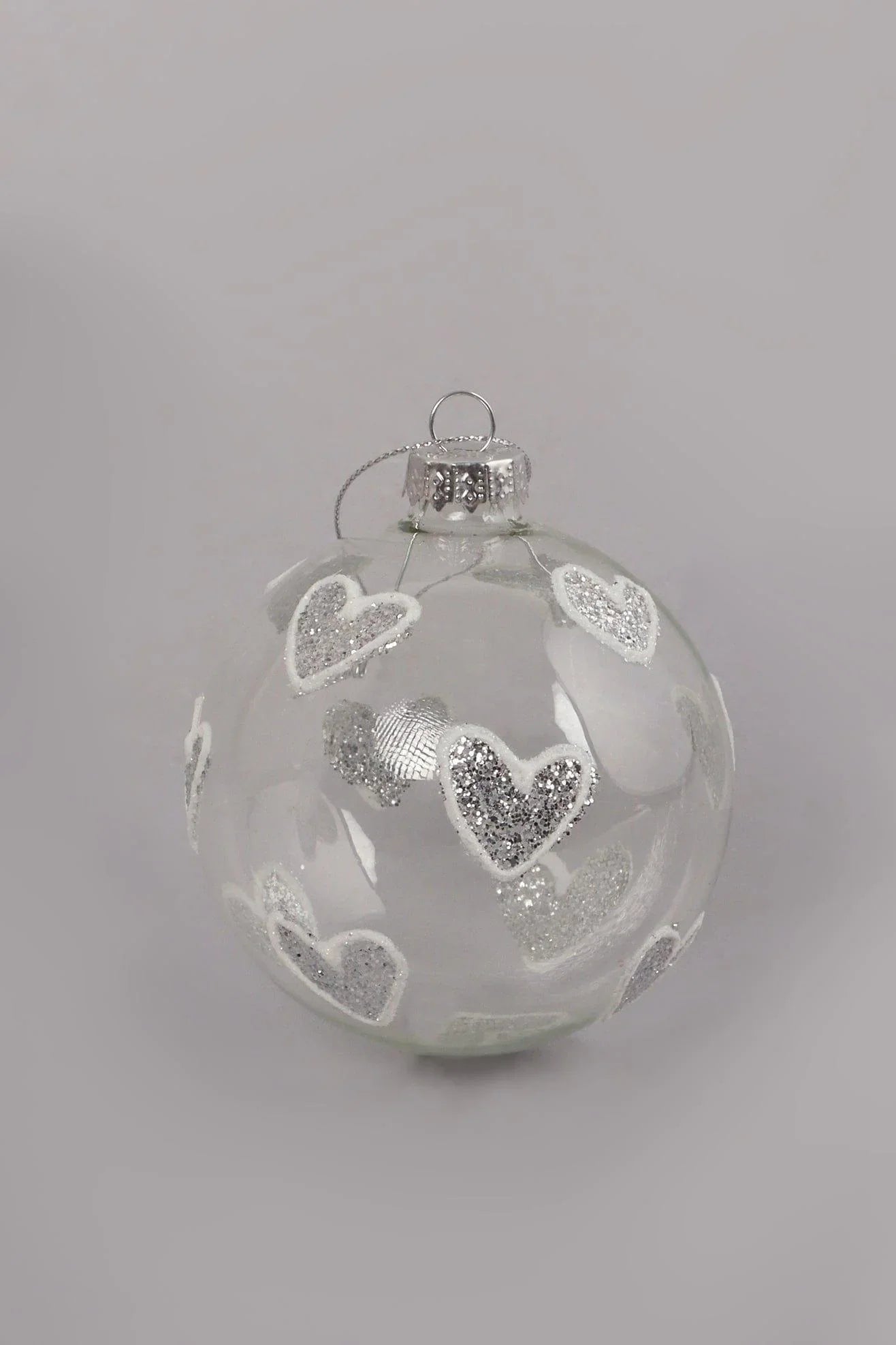 Hand-Blown Clear Glass Christmas Bauble with Silver Glitter Hearts — close-up view, G Decor