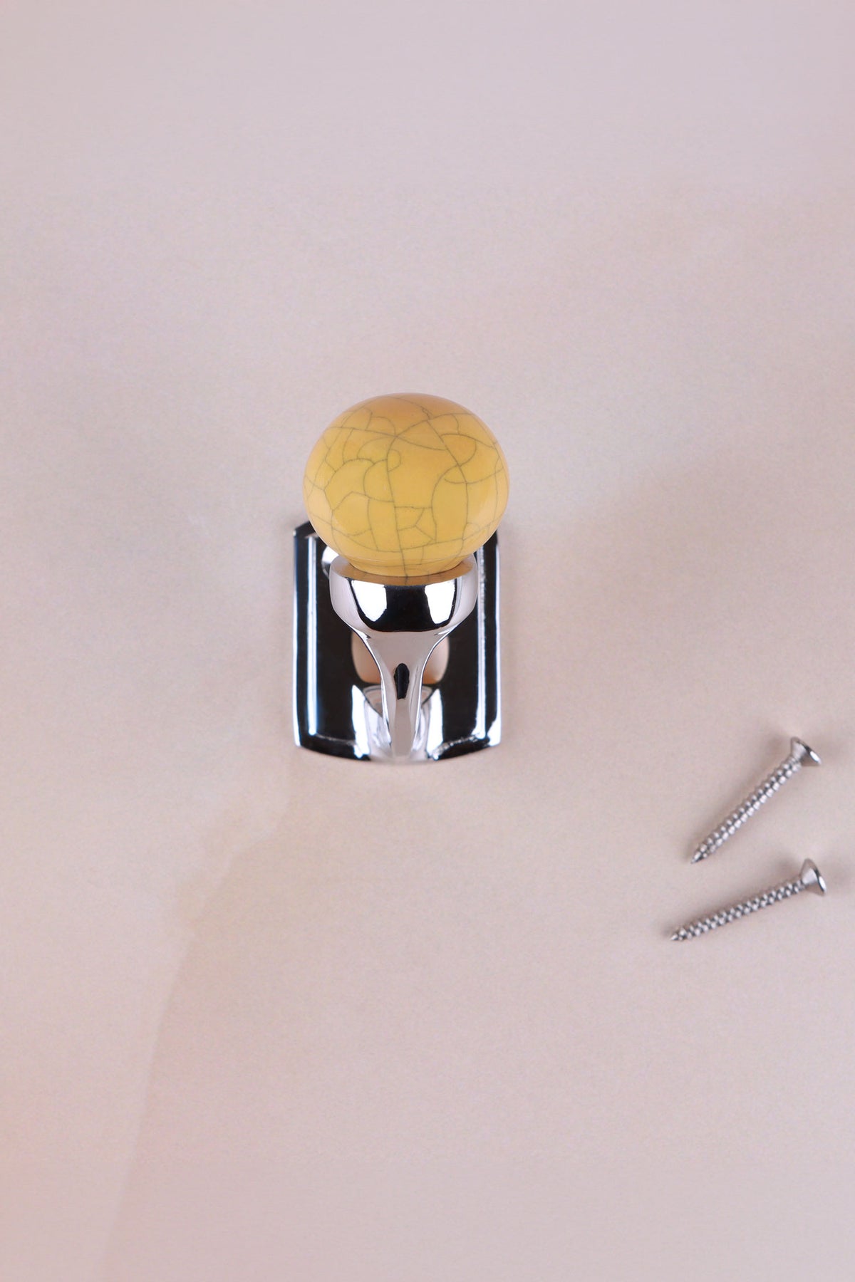 Mustard ochre crackle glaze ceramic ball hook on a chrome finish hook, with its two screws