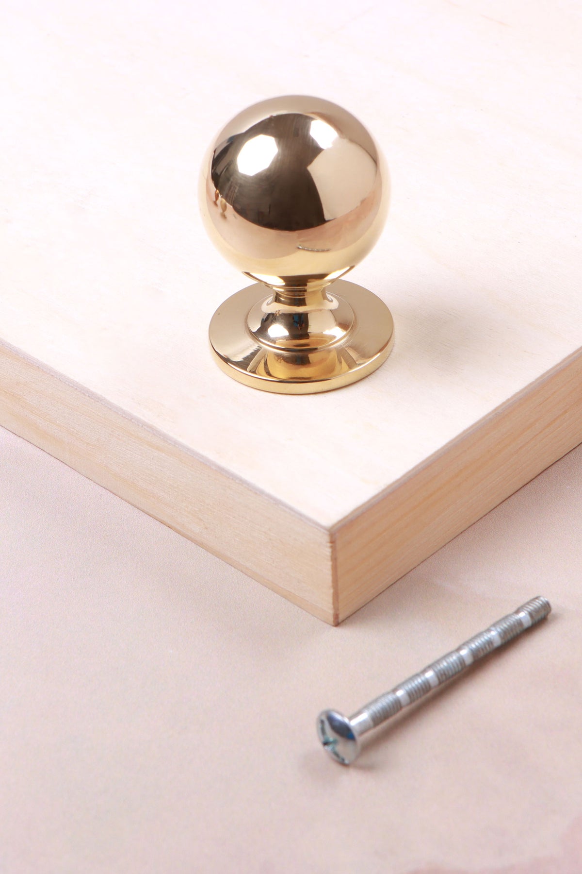 Round cabinet knob in polished brass