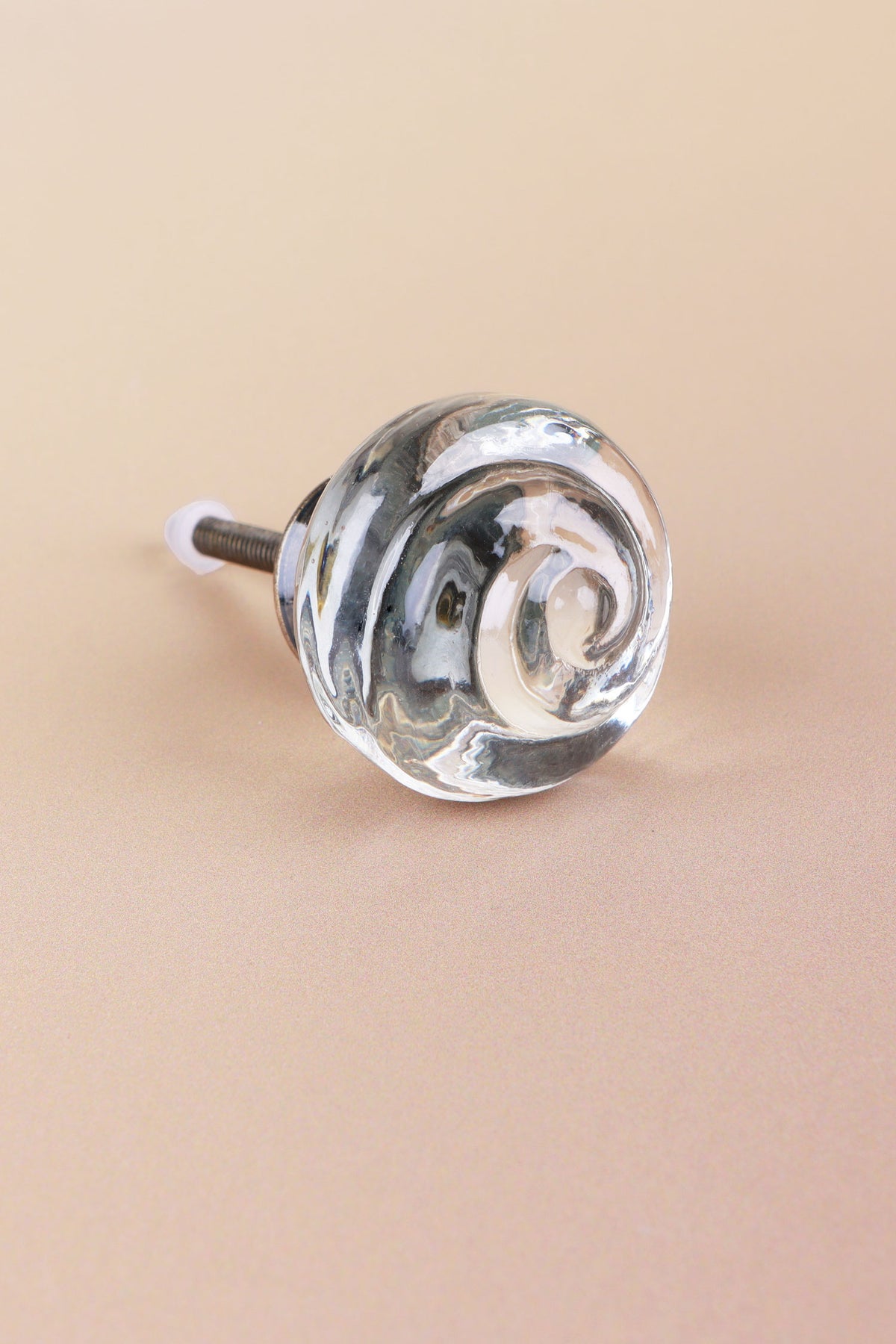 Clear small rose glass cabinet knob, a swirl of glass curling into the centre, on an antique brass finish base