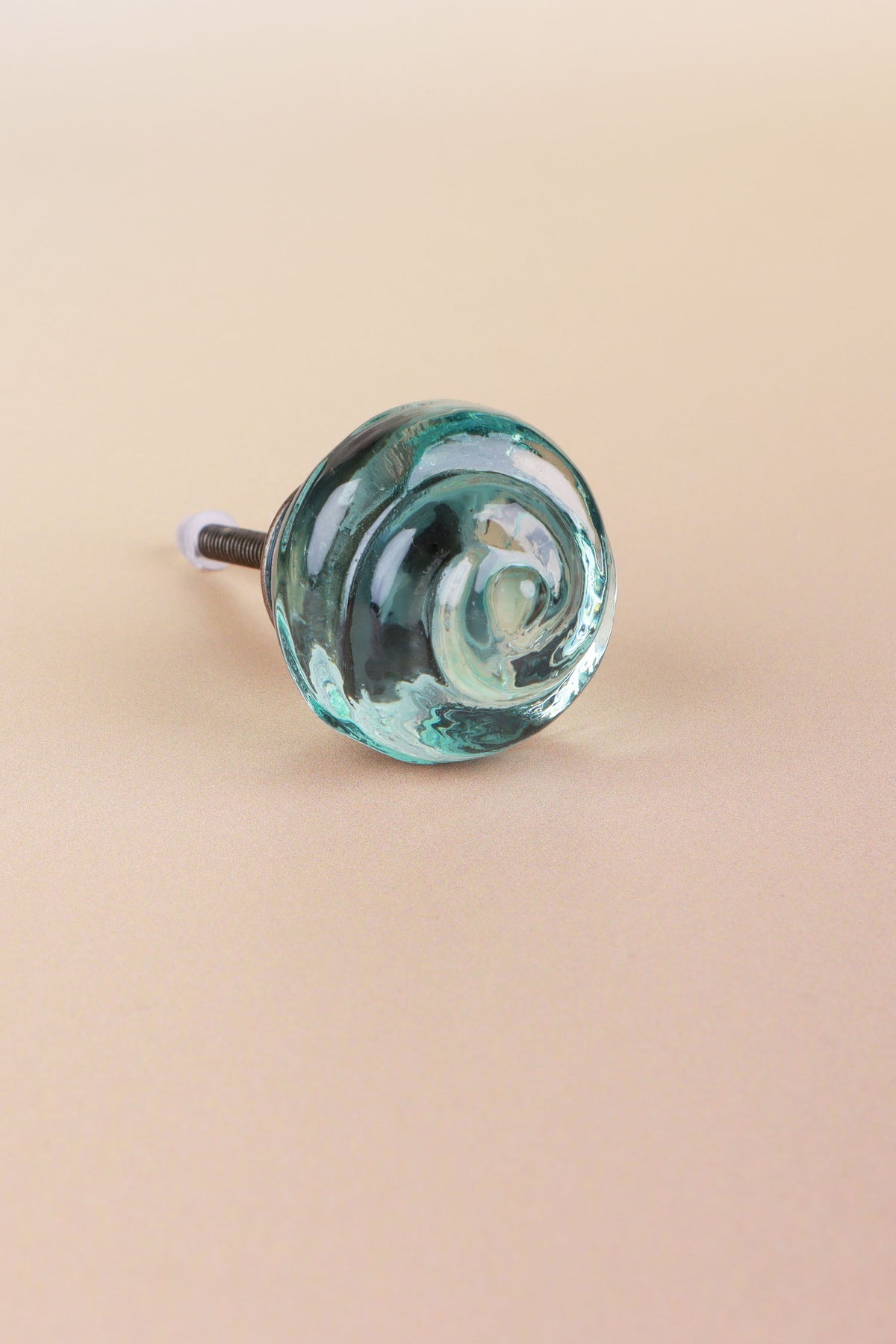 Teal small rose glass cabinet knob, a cool blue-green, with a swirl curling into the centre, on an antique brass finish base