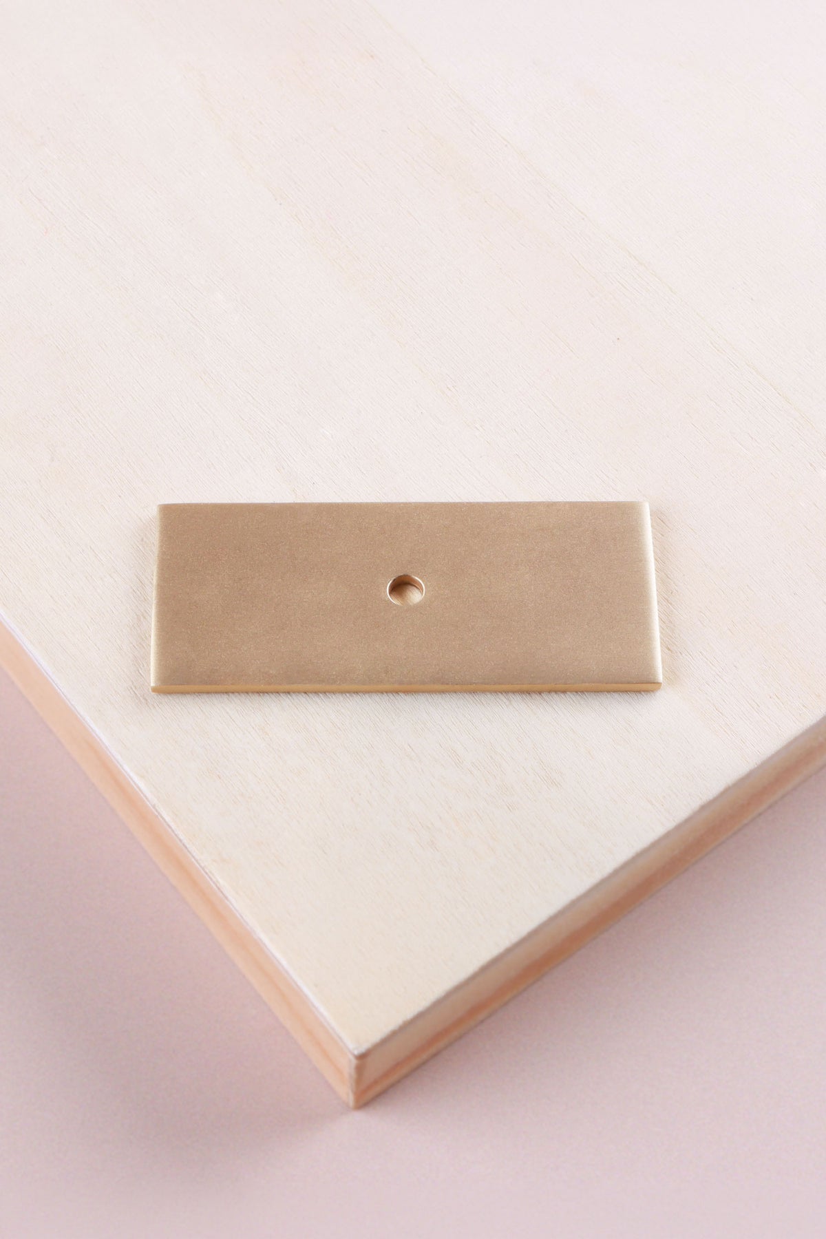 Satin brass rectangle backplate, 60 x 25mm: solid brass with a 4mm centre hole for the knob bolt