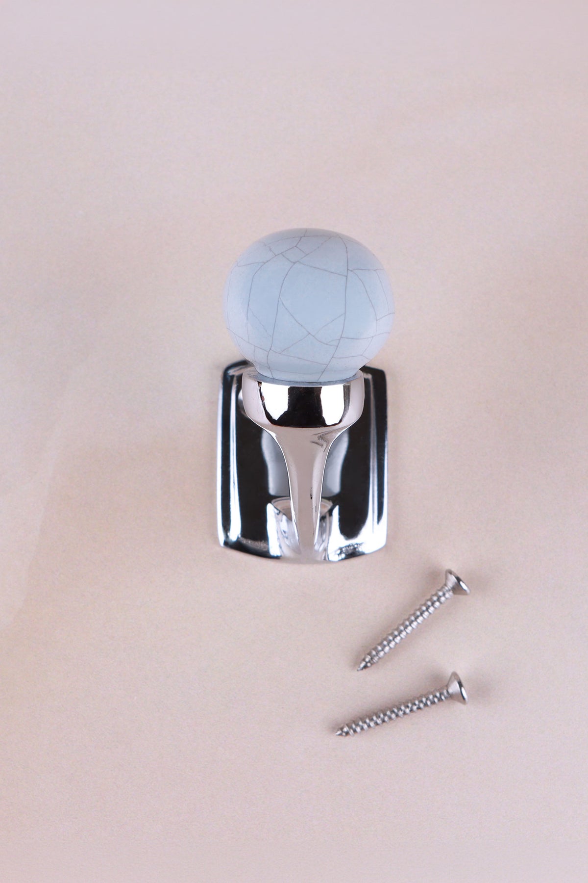 Smoke grey crackle glaze ceramic ball hook, a pale blue-grey, on a chrome finish hook with its two screws